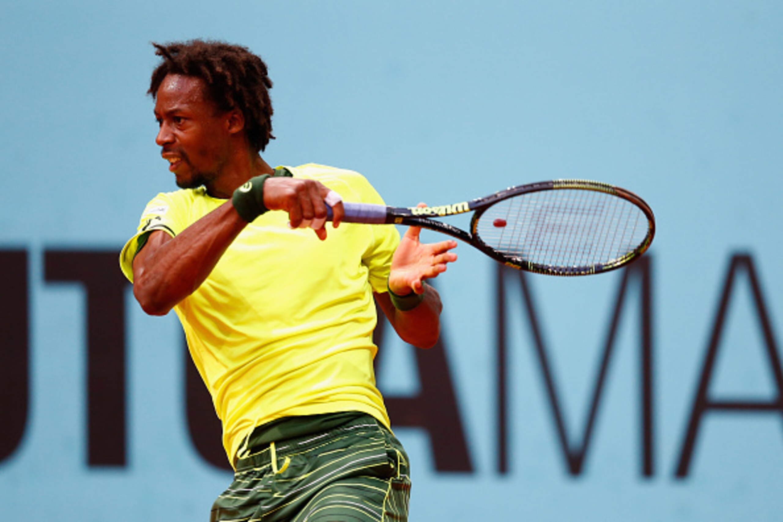 Gael Monfils hits a forehand during a match at the 2015 Mutua Madrid Open.