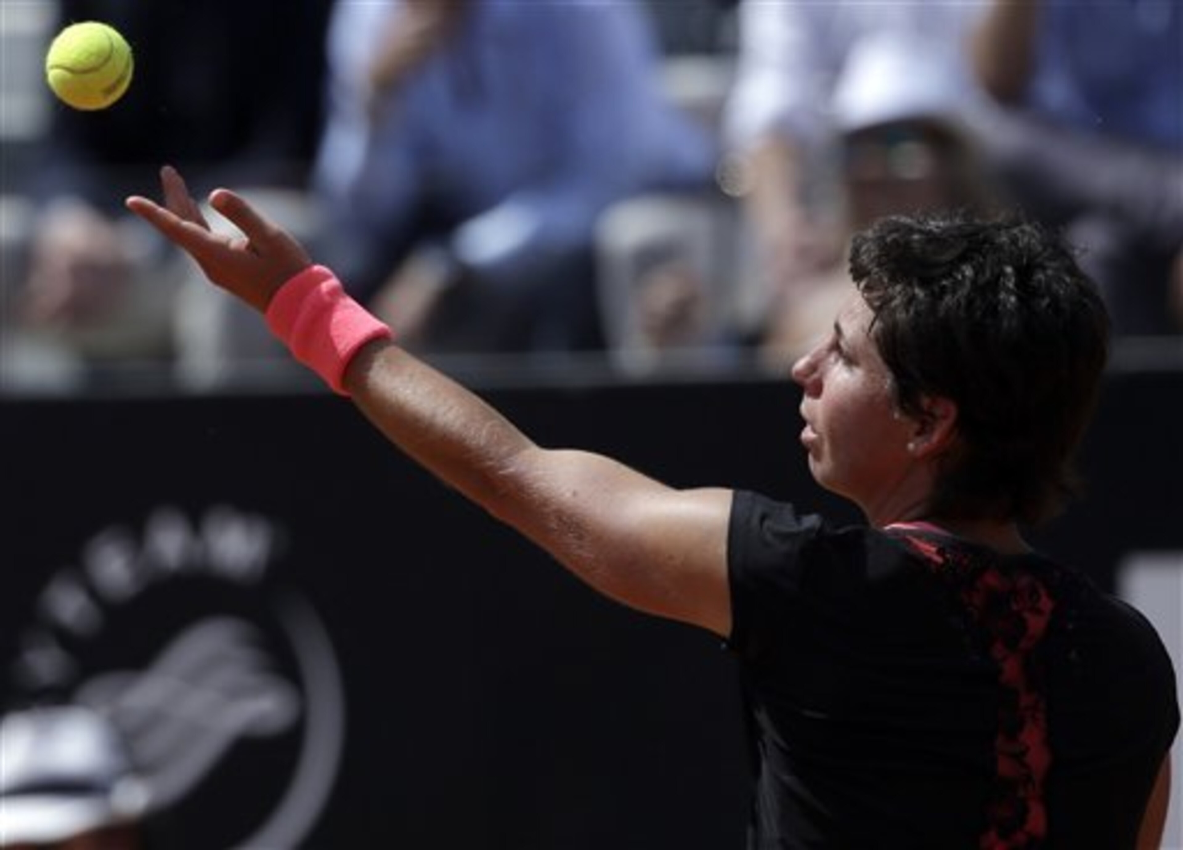 Carla Suarez Navarro serves during the final of the Italian Open.