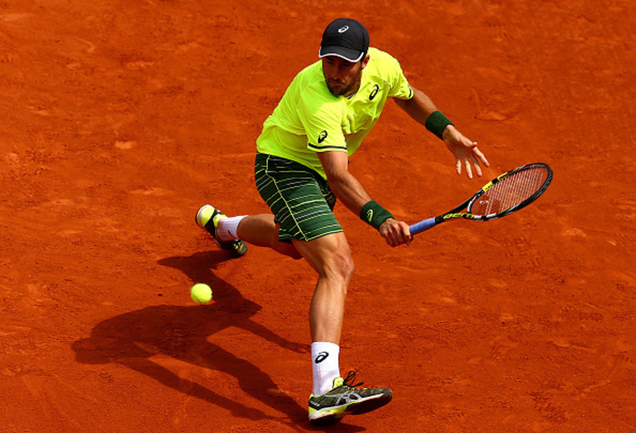 Steve Johnson slides to the ball during a match at the 2015 French Open.