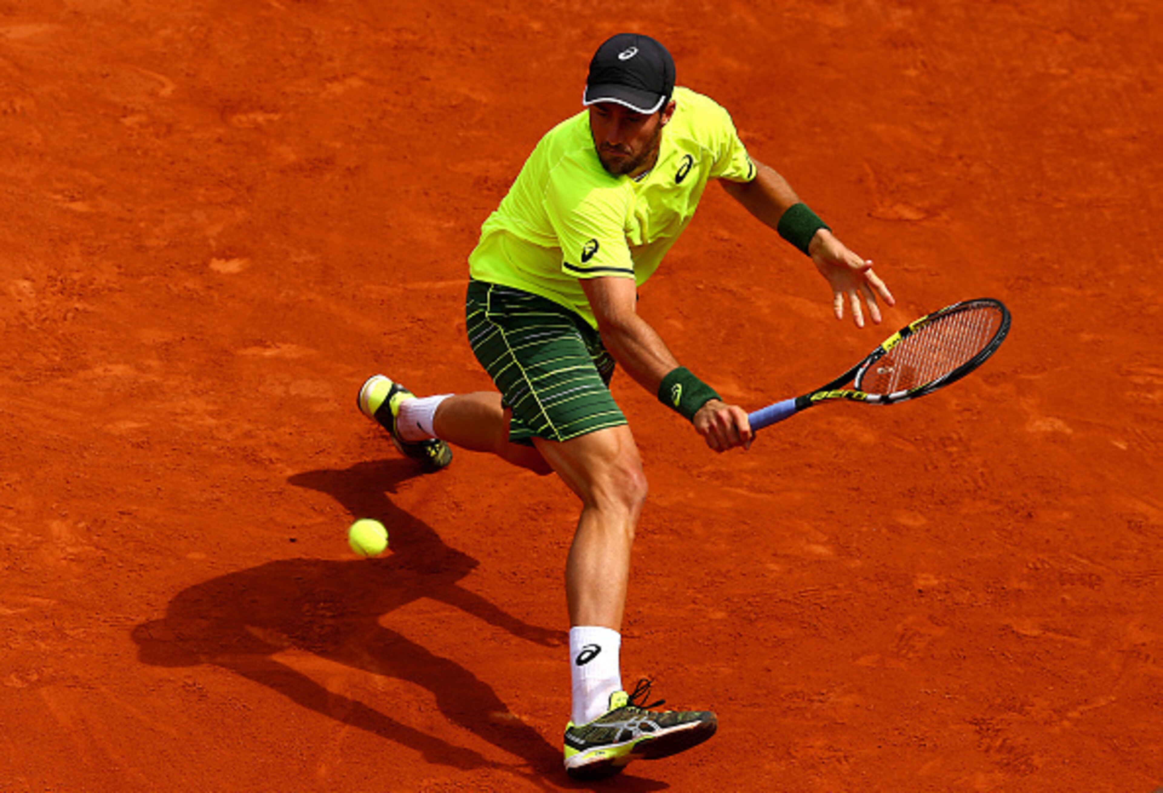 Steve Johnson slides to the ball during a match at the 2015 French Open.