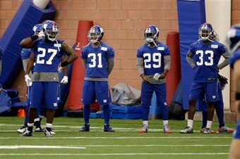 Members of the Giants secondary stand by at practice.