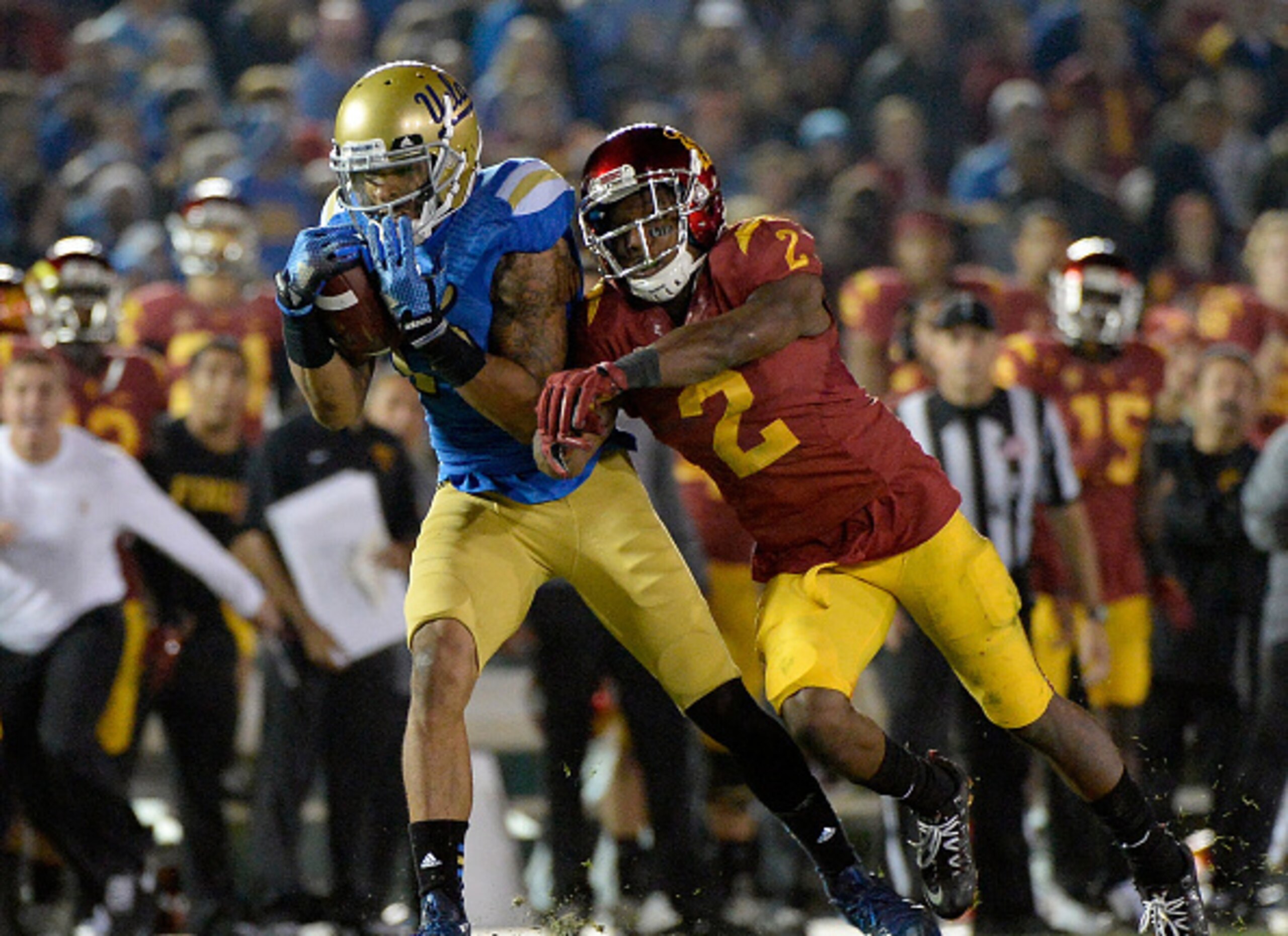 PASADENA, CA - NOVEMBER 22:  Devin Lucien #15 of the UCLA Bruins makes a catch in front of Adoree' Jackson #2 of the USC Trojans during a 38-20 UCLA win at the Rose Bowl on November 22, 2014 in Pasadena, California.  (Photo by Harry How/Getty Images)