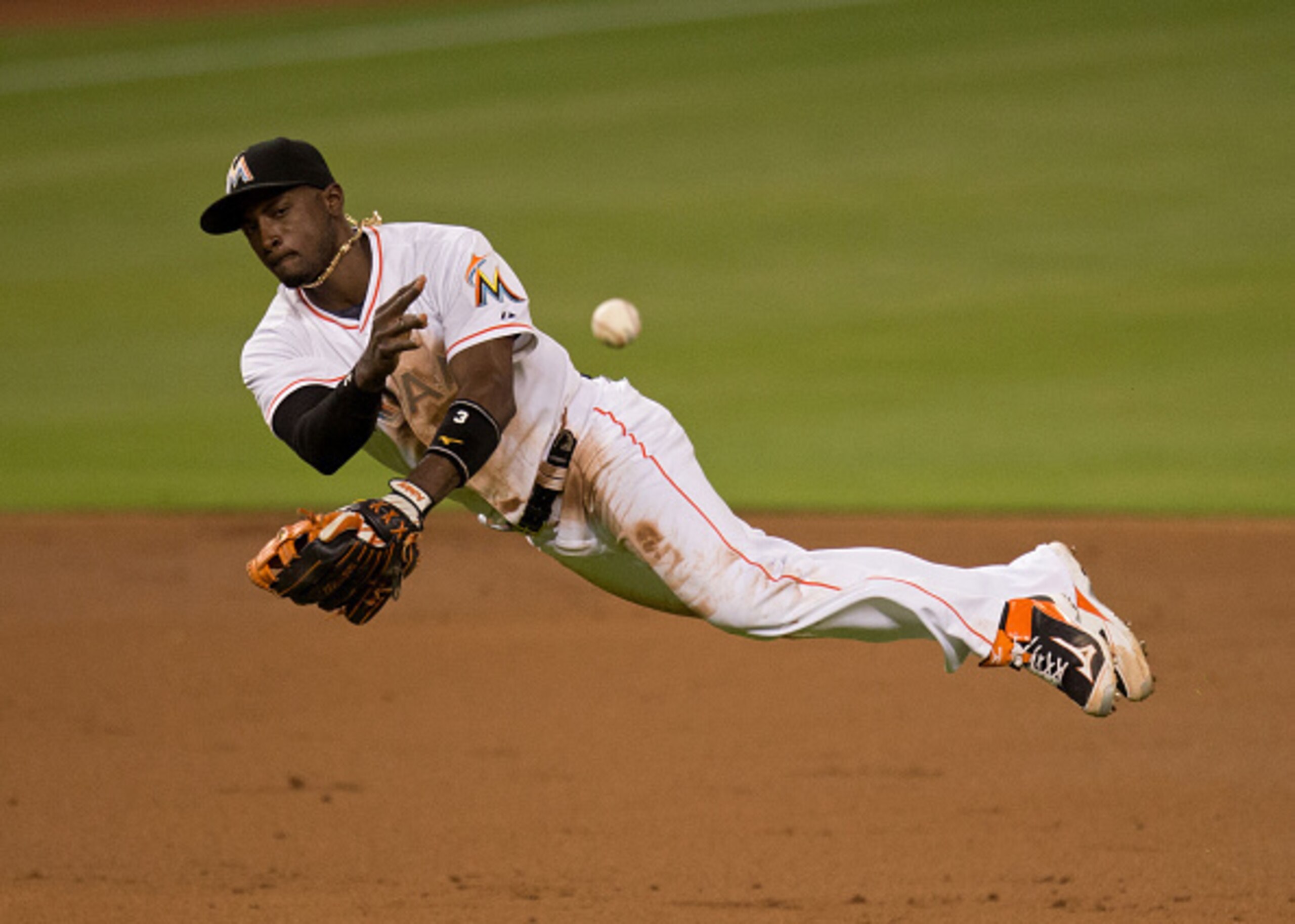 MIAMI, FL - JUNE 11:  Adeiny Hechavarria #3 of the Miami Marlins throws to first base during the third inning of the game against the Colorado Rockies at Marlins Park on June 11, 2015 in Miami, Florida.  (Photo by Rob Foldy/Getty Images)