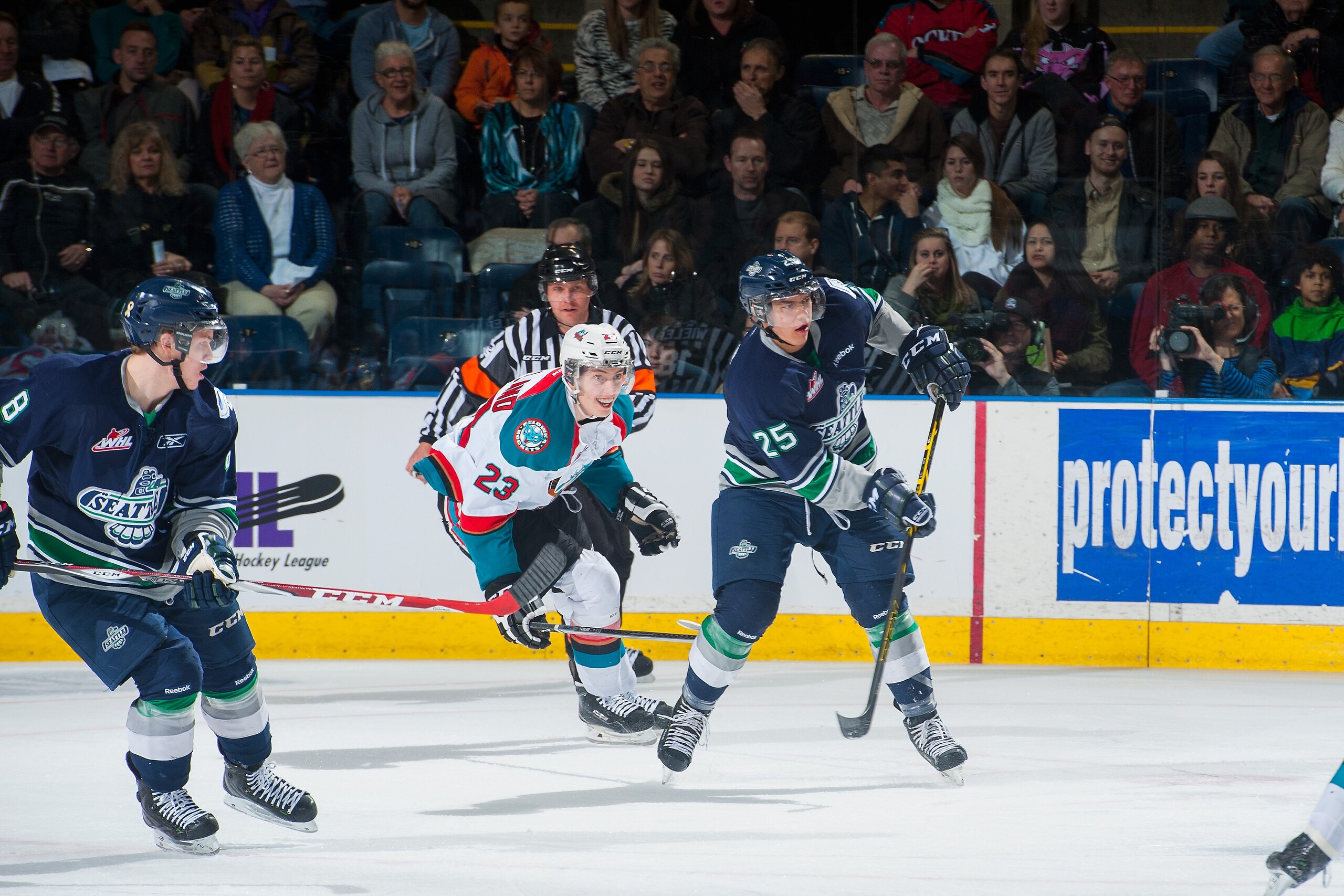 Ethan Bear (#25 in blue) makes a pass for the WHL's Seattle Thunderbirds.