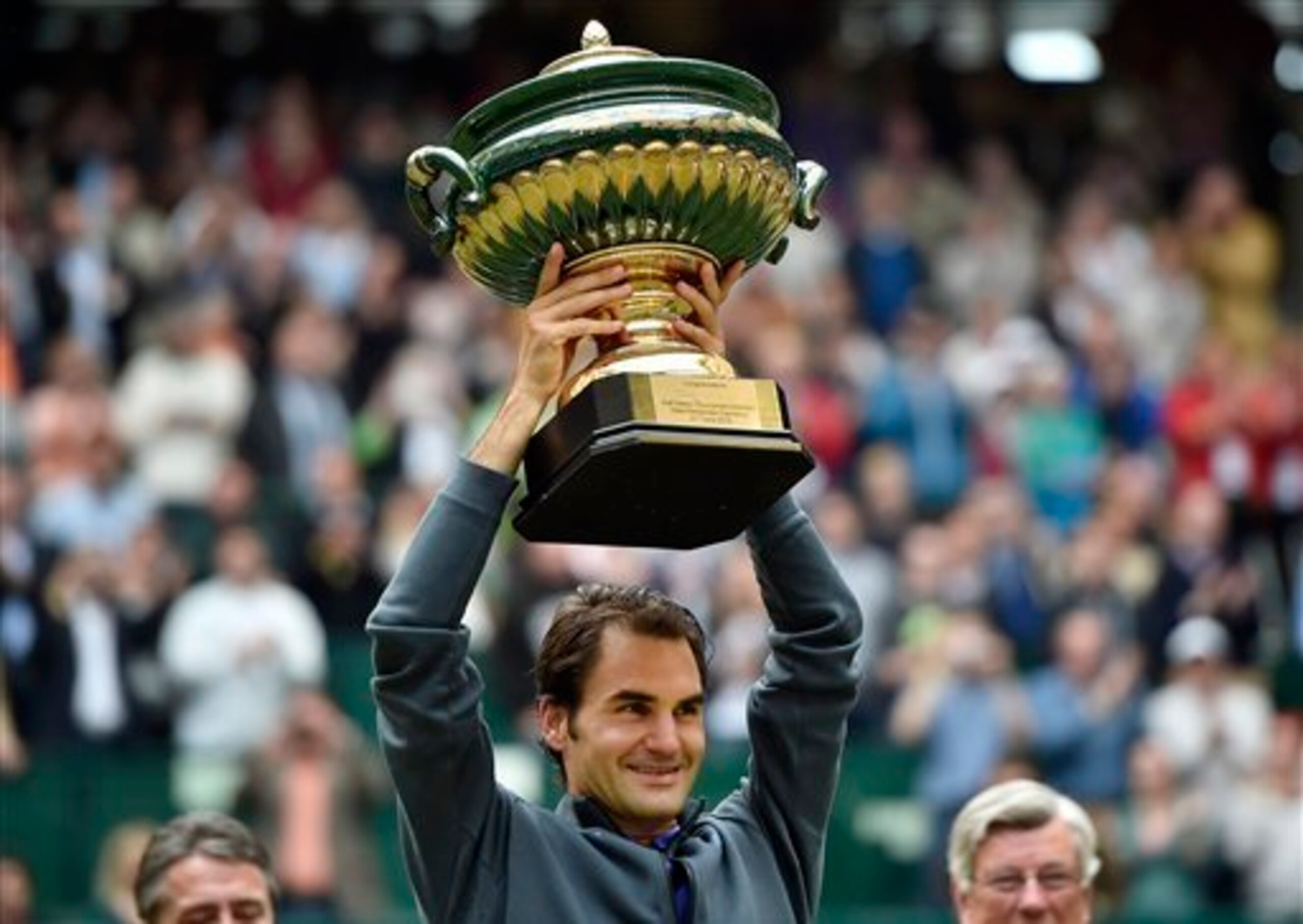 Roger Federer raises his trophy after winning the 2015 Gerry Weber Open  in Halle, Germany.