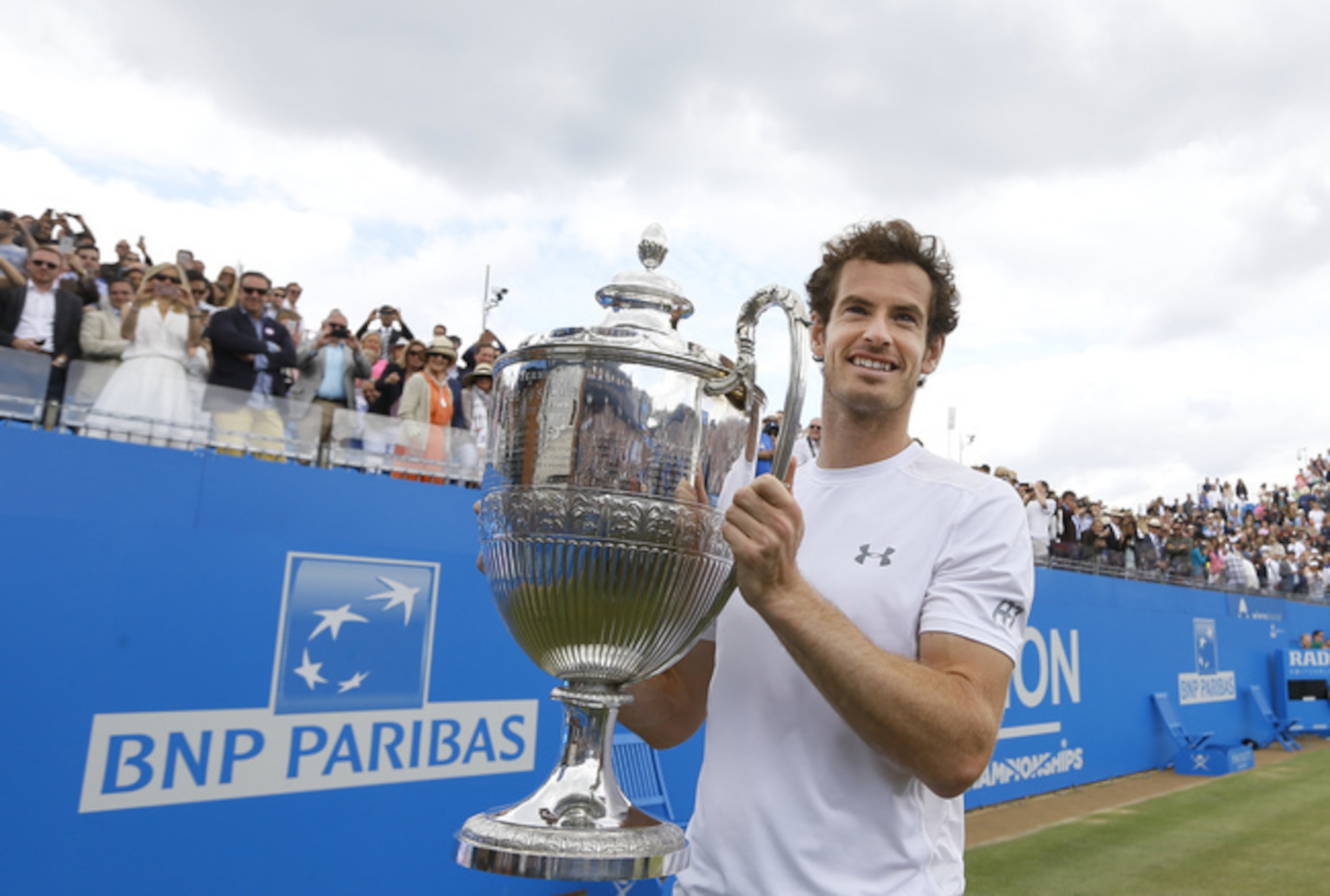 Andy Murray poses with the trophy after winning the Queen's Club Championships in London.