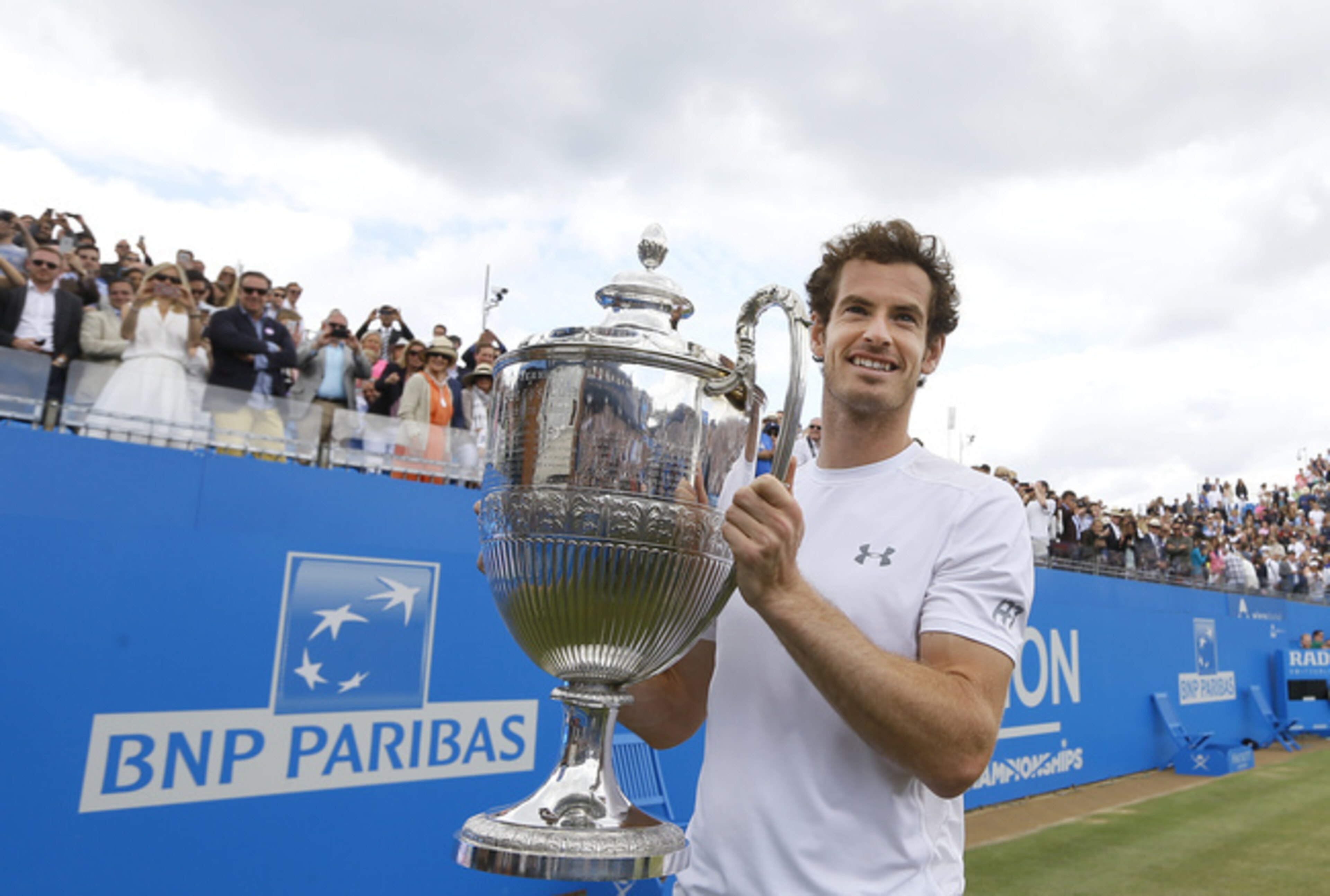 Andy Murray poses with the trophy after winning the Queen's Club Championships in London.
