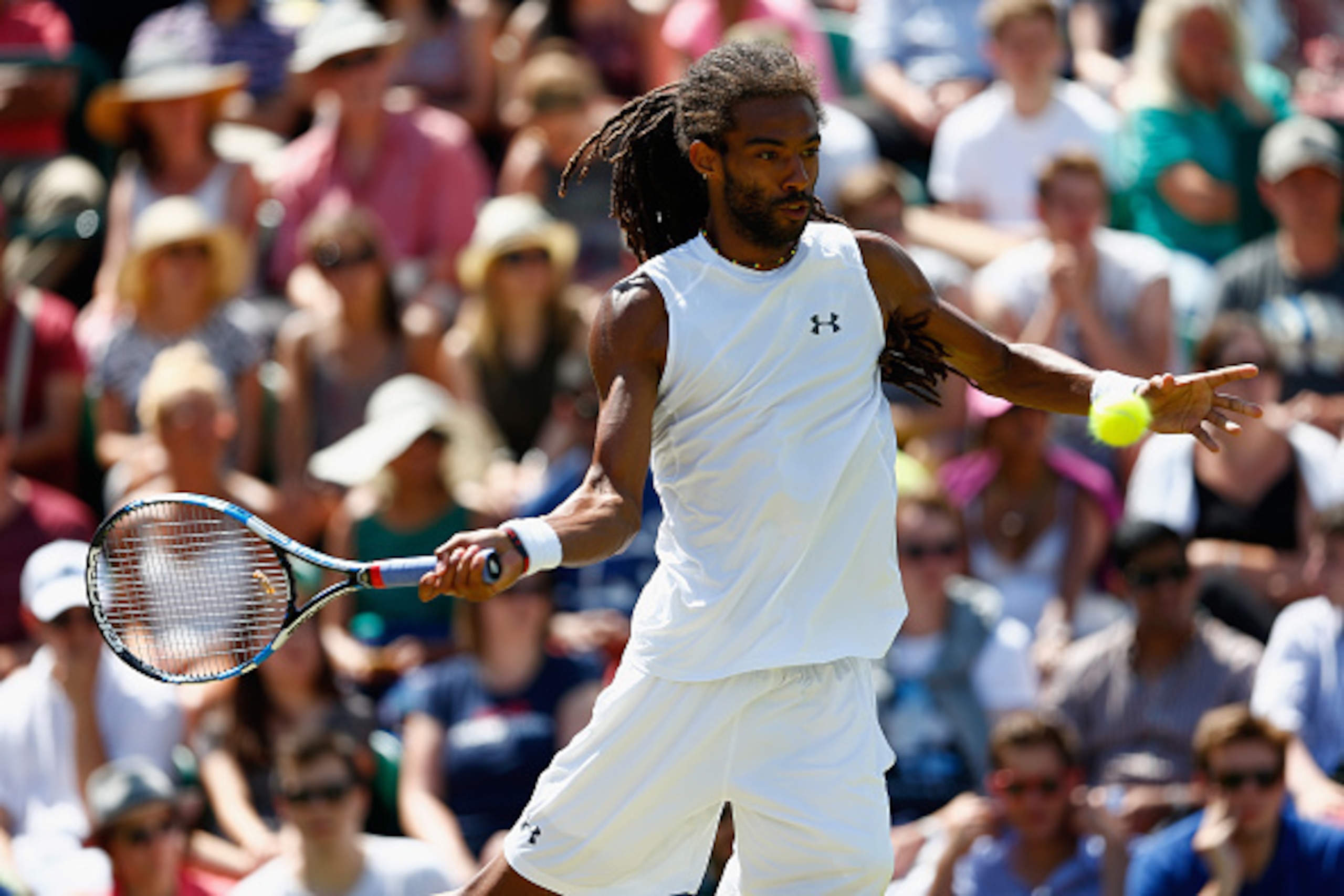Dustin Brown hits a forehand during a match at Wimbledon.
