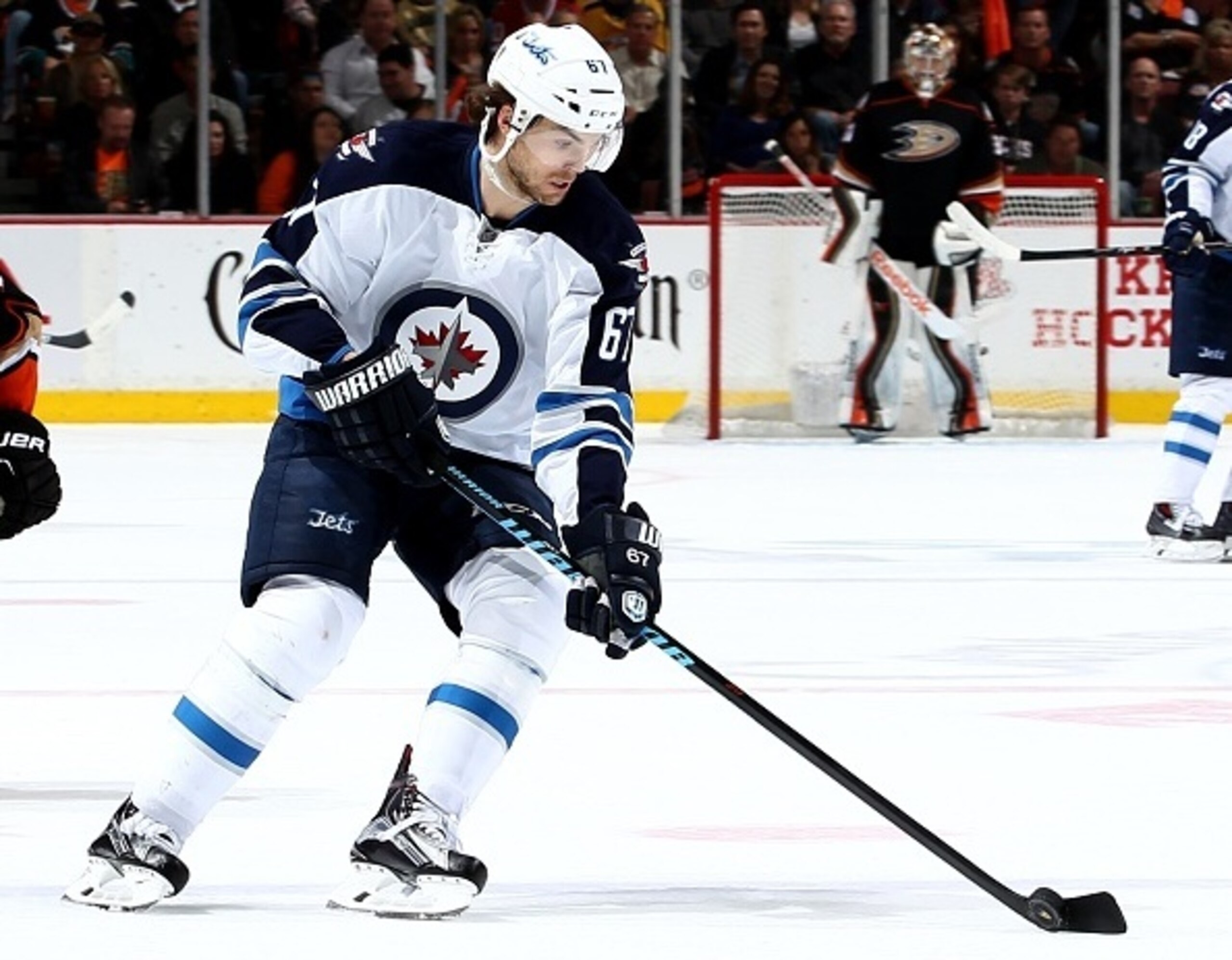 Michael Frolik carries the puck through the neutral zone.