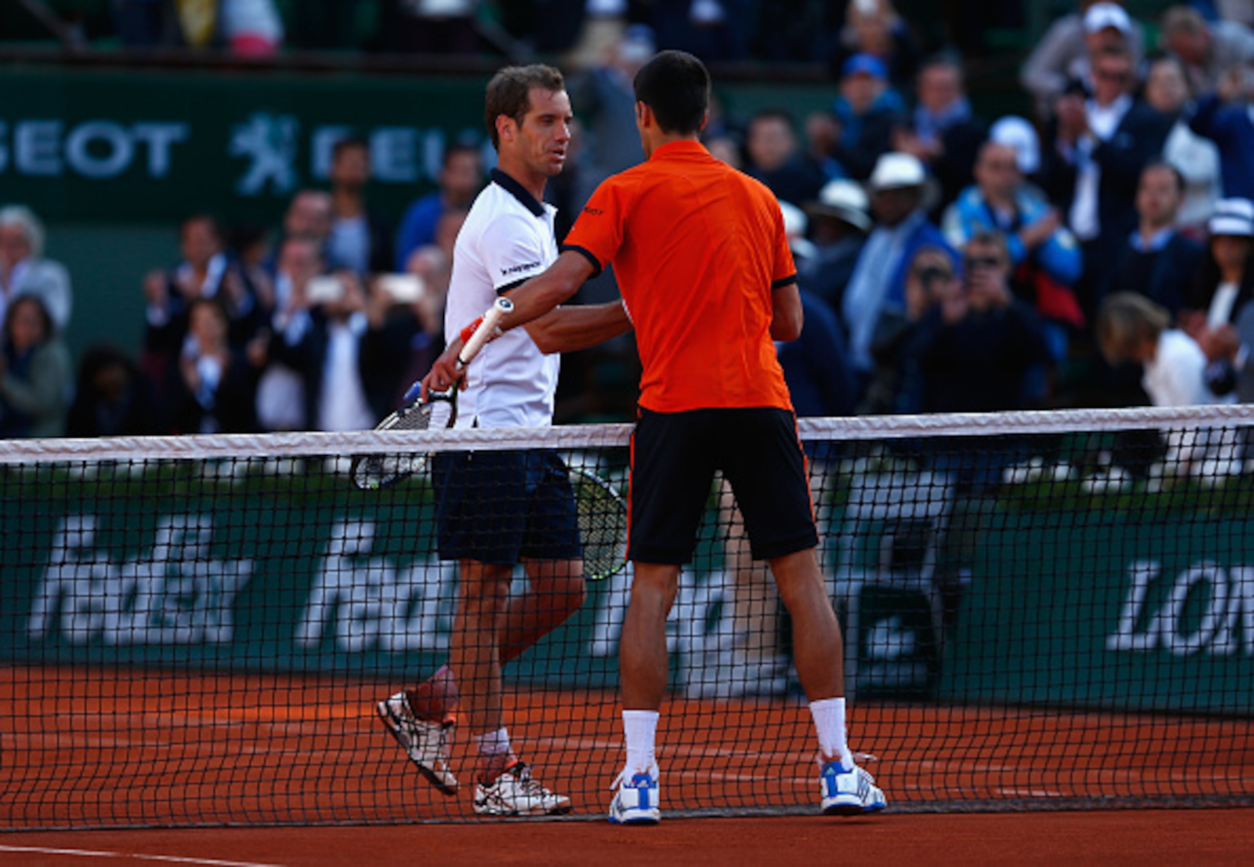 Richard Gasquet and Novak Djokovic shake hands after their match at the French Open.