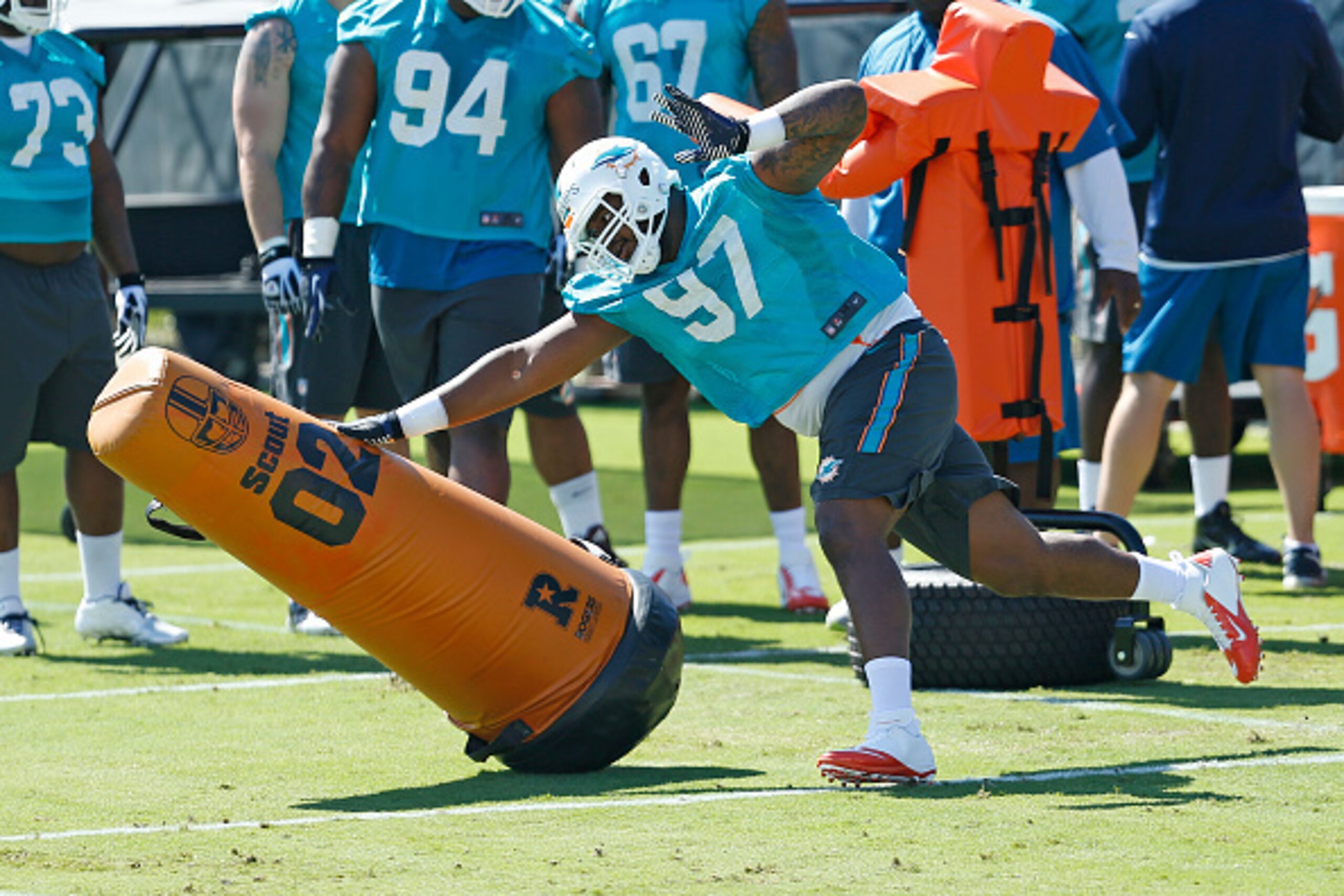 Defensive tackle Jordan Phillips (97, above) may not  be competing for a starting job this year, but he will be in the Dolphins' long-term plans on the defensive line.