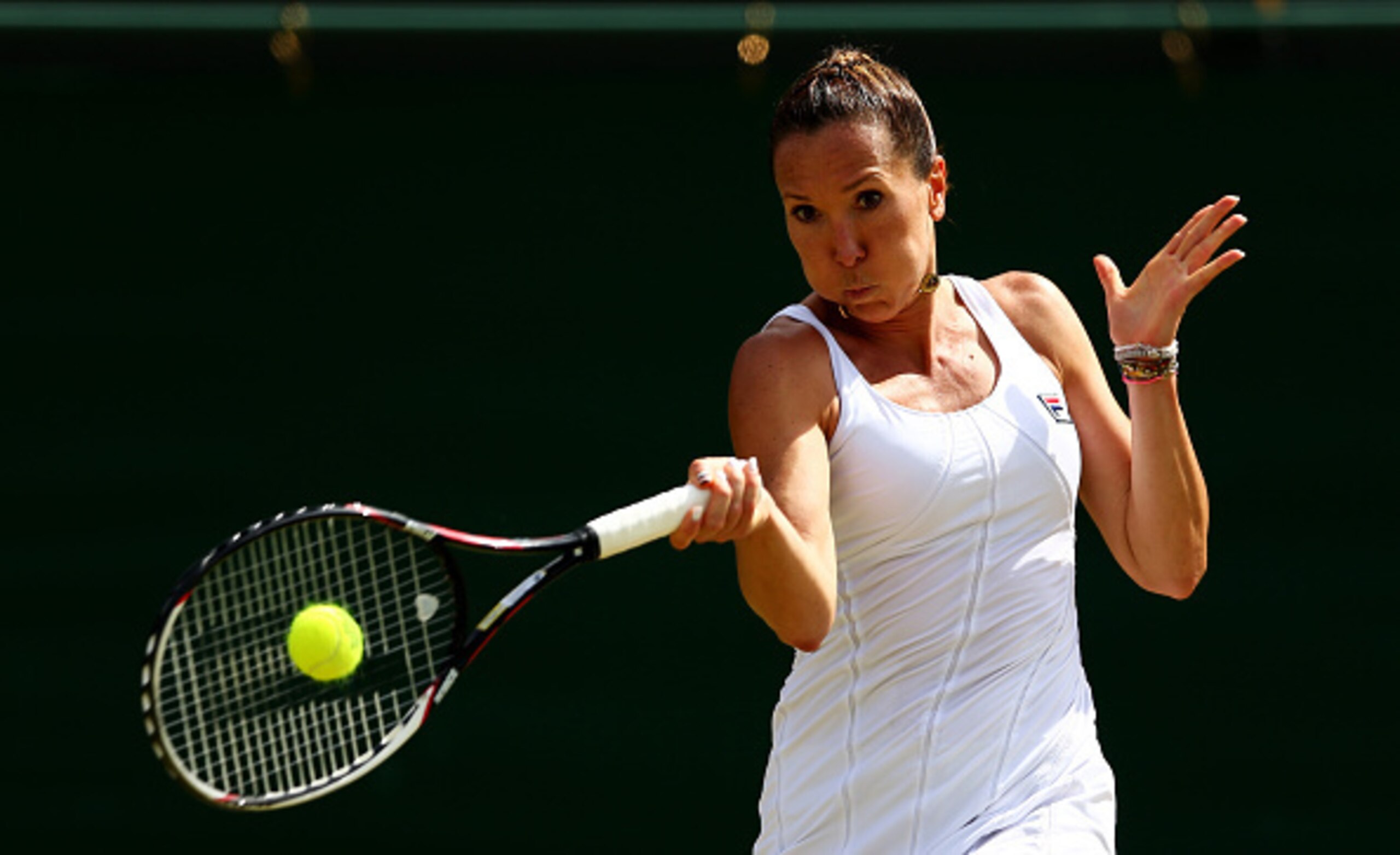 LONDON, ENGLAND - JULY 06:  Jelena Jankovic of Serbia plays a forehand in her Ladies' Singles Fourth Round match against Agnieszka Radwanska of Poland during day seven of the Wimbledon Lawn Tennis Championships at the All England Lawn Tennis and Croquet C