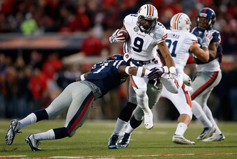OXFORD, MS - NOVEMBER 01:  Roc Thomas #9 of the Auburn Tigers carries the ball and is tackled by Trae Elston #7 of the Mississippi Rebels at Vaught-Hemingway Stadium on November 1, 2014 in Oxford, Mississippi.  (Photo by Doug Pensinger/Getty Images)