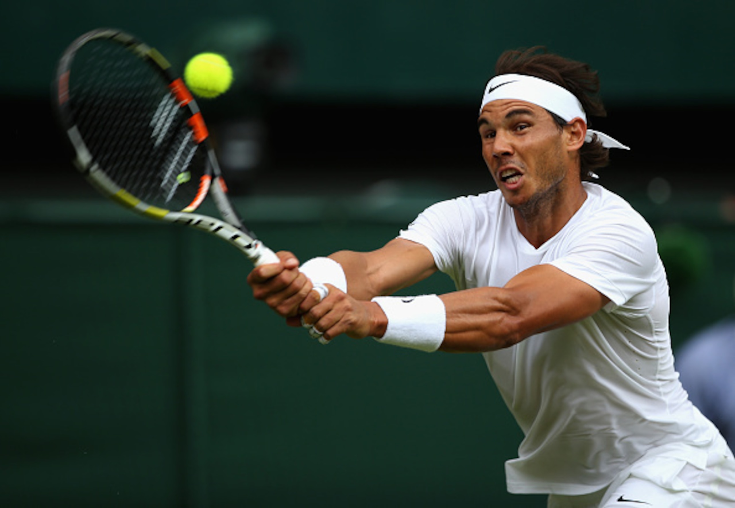 Rafael Nadal hits a backhand at the 2015 Wimbledon championships.