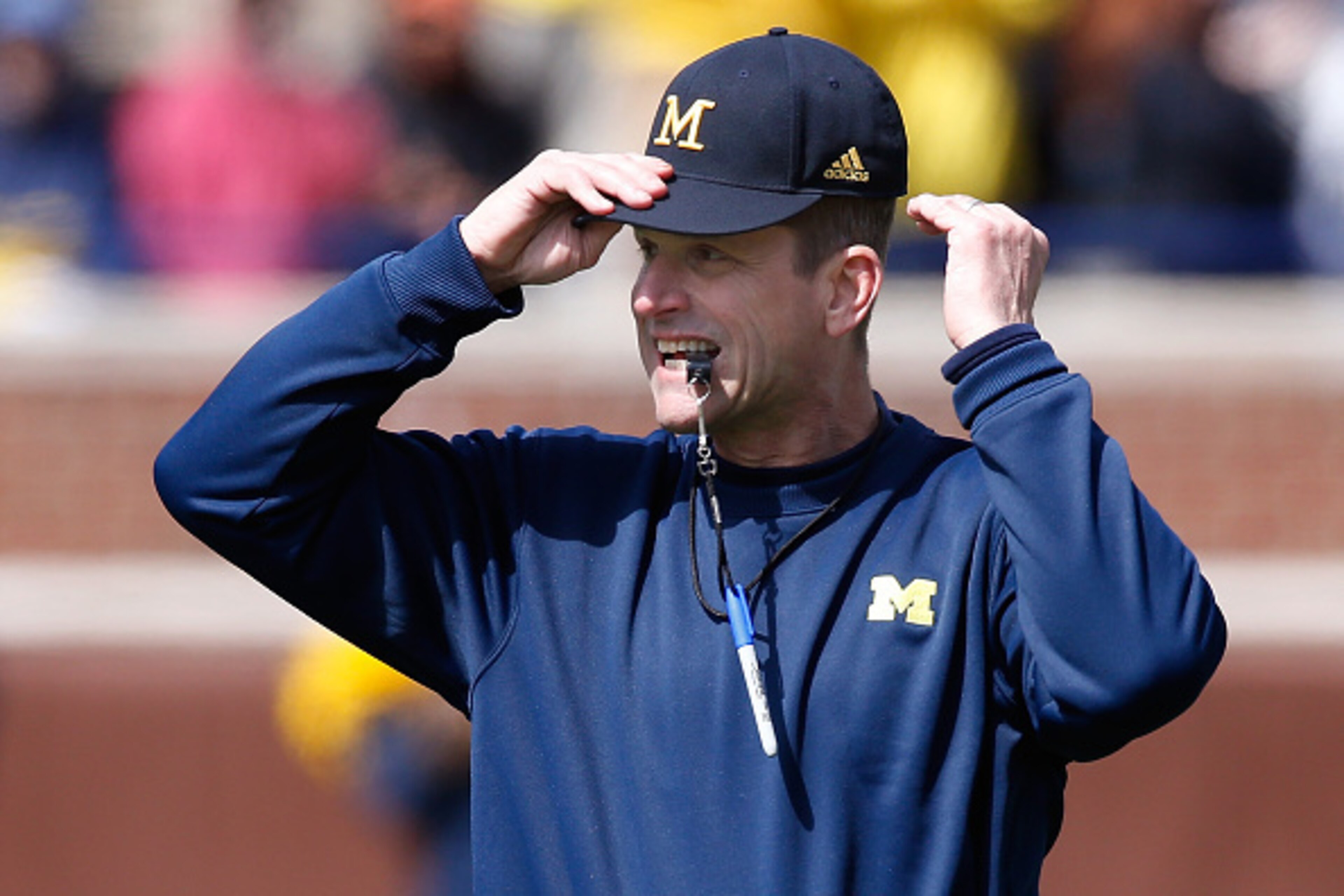 Jim Harbaugh wasted no time re-introducing himself to college football as Michigan's new head coach.
