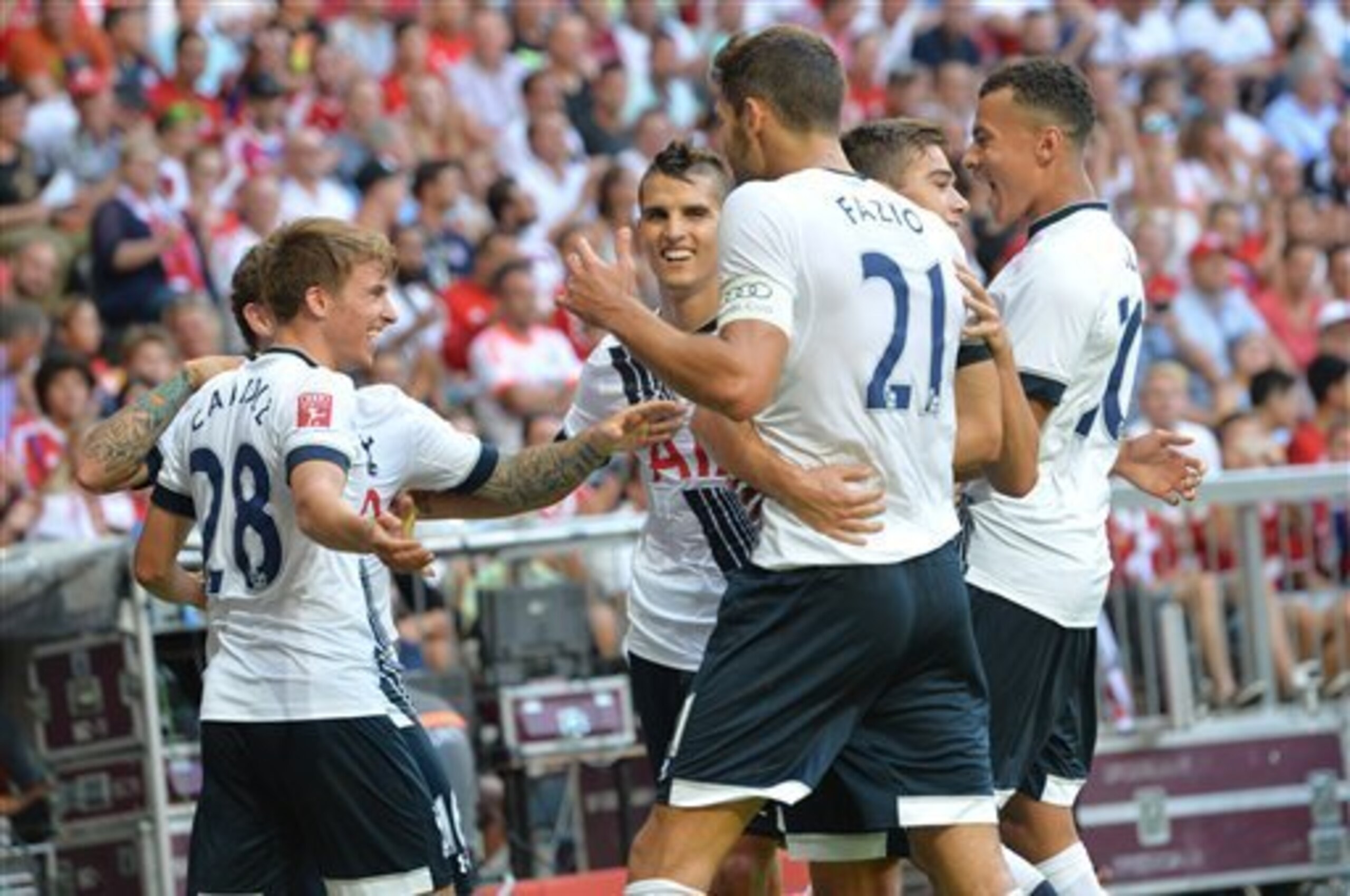 Tottenham celebrate their second goal after cutting straight through the MIlan defence.