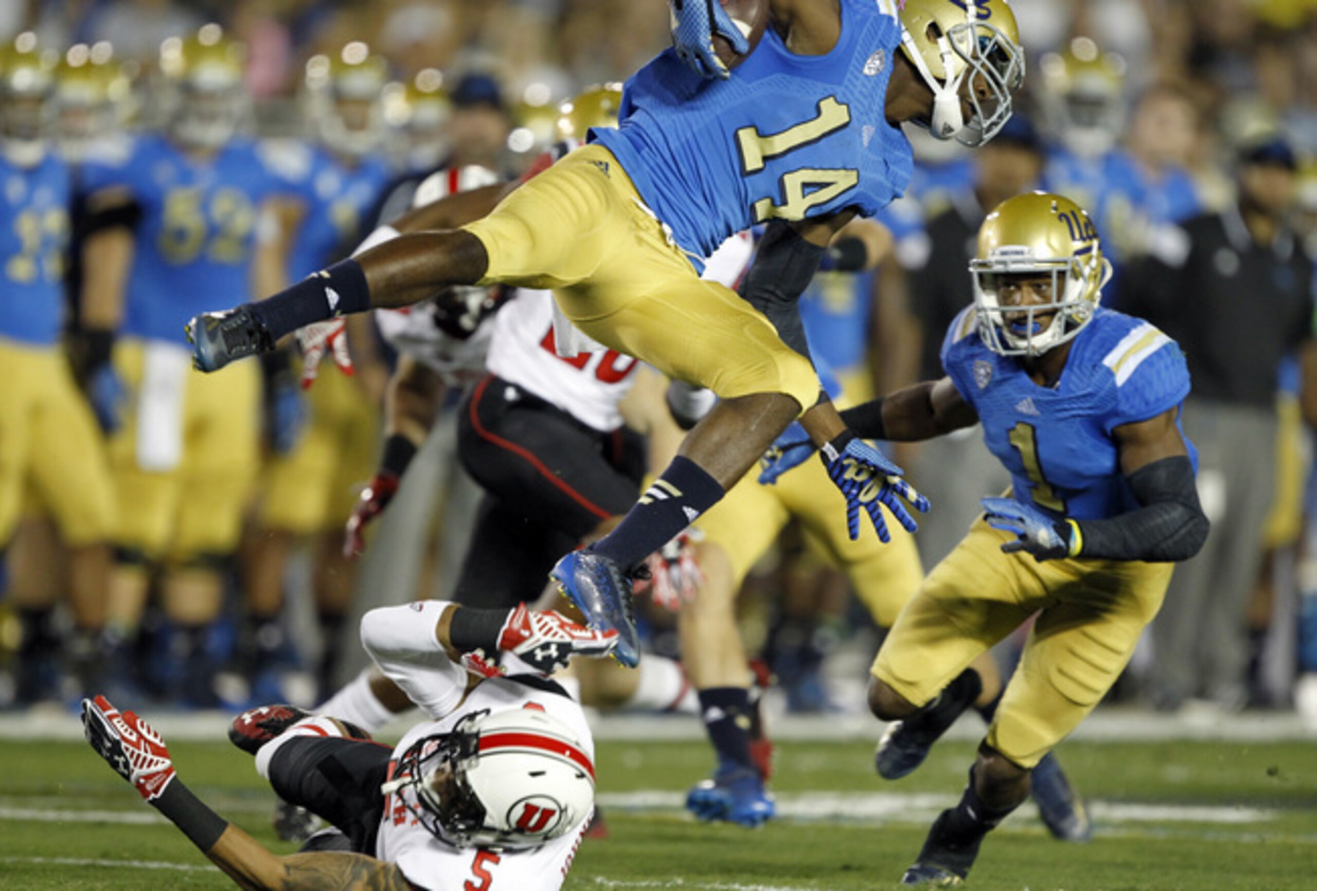 Mossi Johnson leaping over a defender.