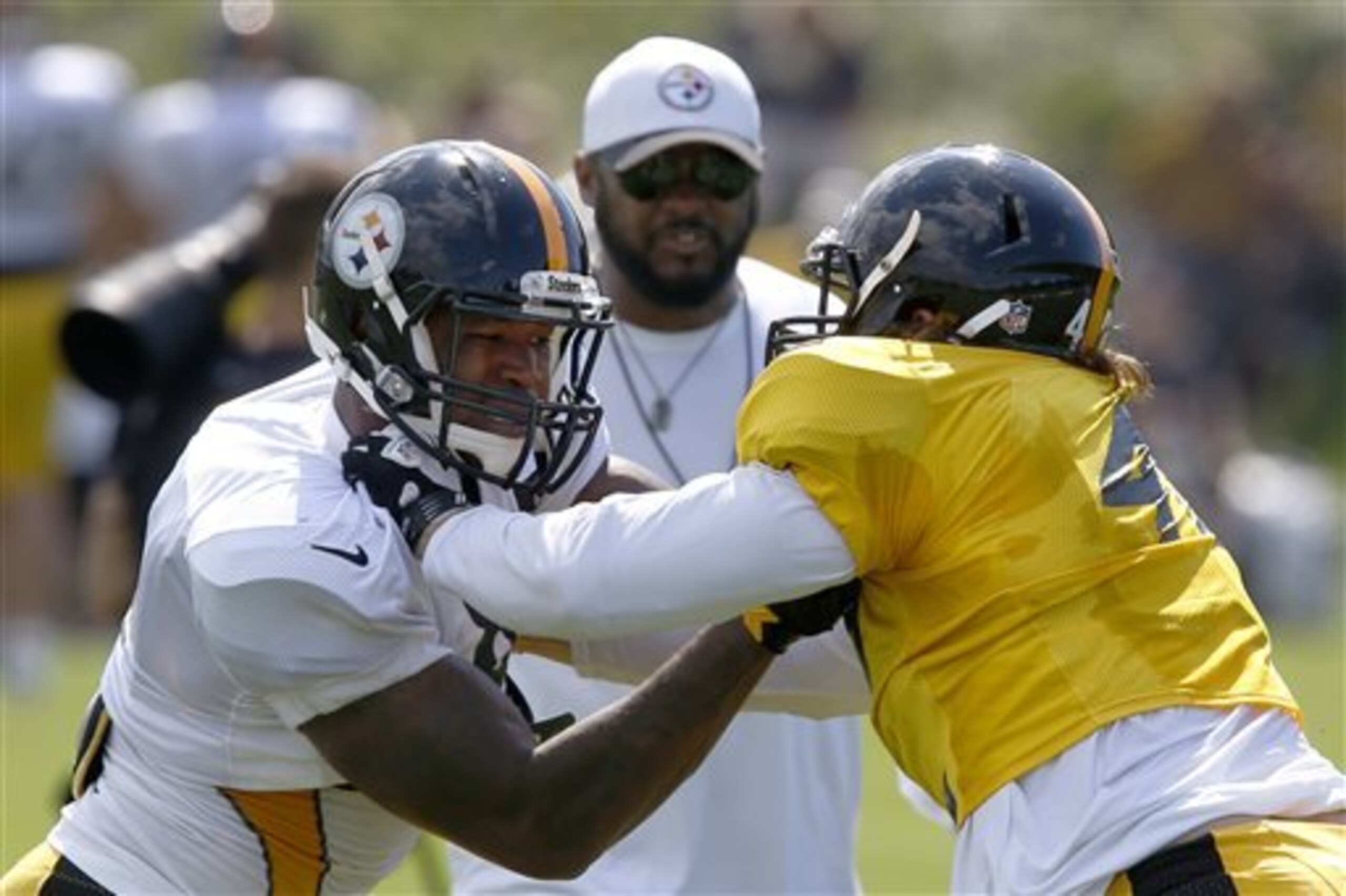 Mike Tomlin observes as Anthony Chickillo (right) participates in the backs-on-backers drill.