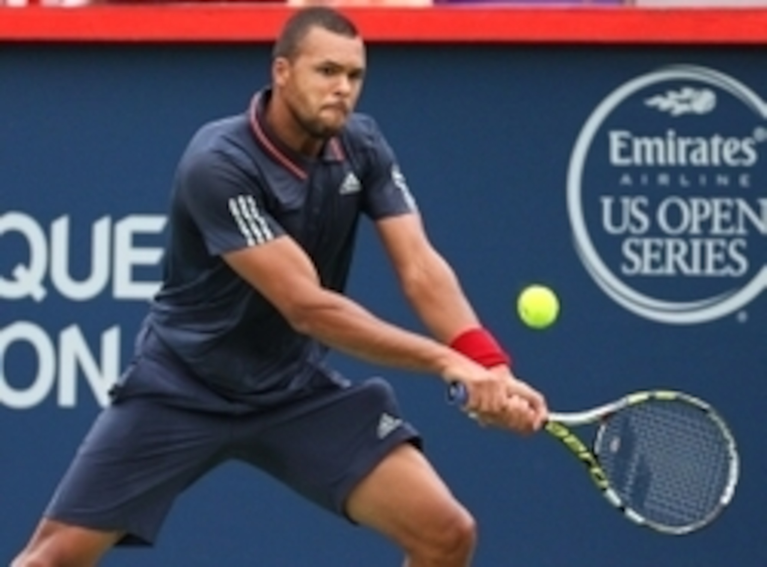 Jo-Wilfried Tsonga hits a backhand during his opening match at the 2015 Rogers Cup.
