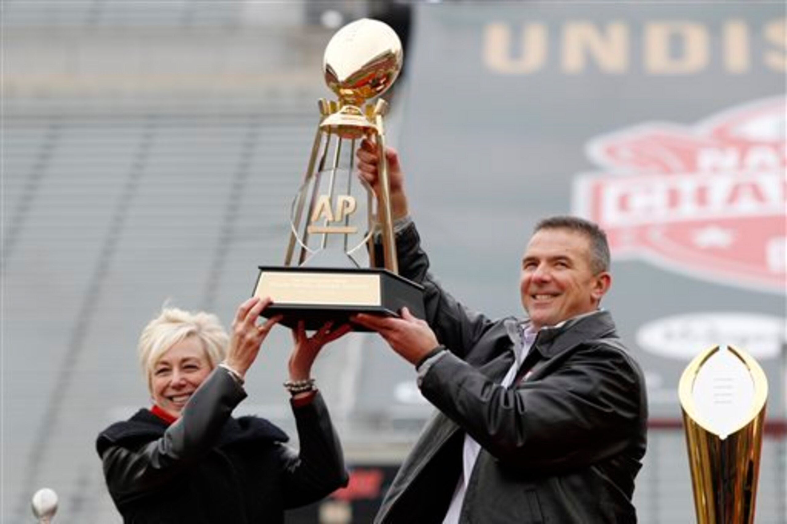 Ohio State HC Urban Meyer with the 2014 AP championship trophy