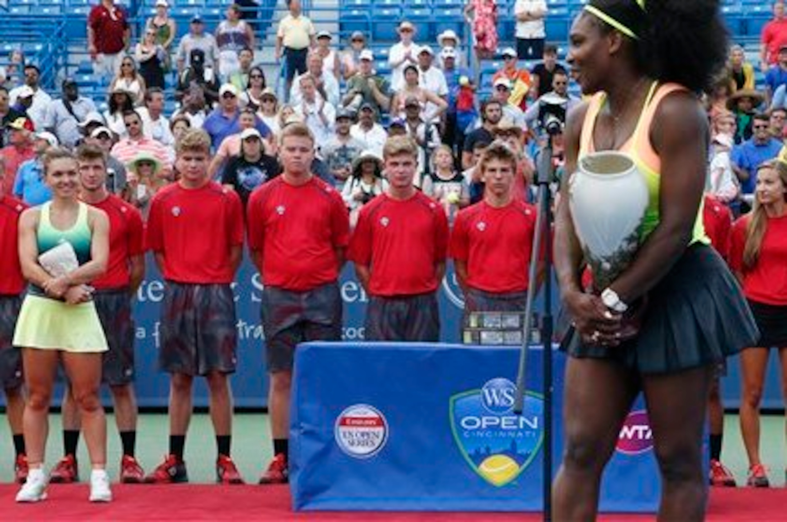 Simona Halep looks on as Serena Williams addresses the Cincinnati crowd after winning the Western & Southern Open.