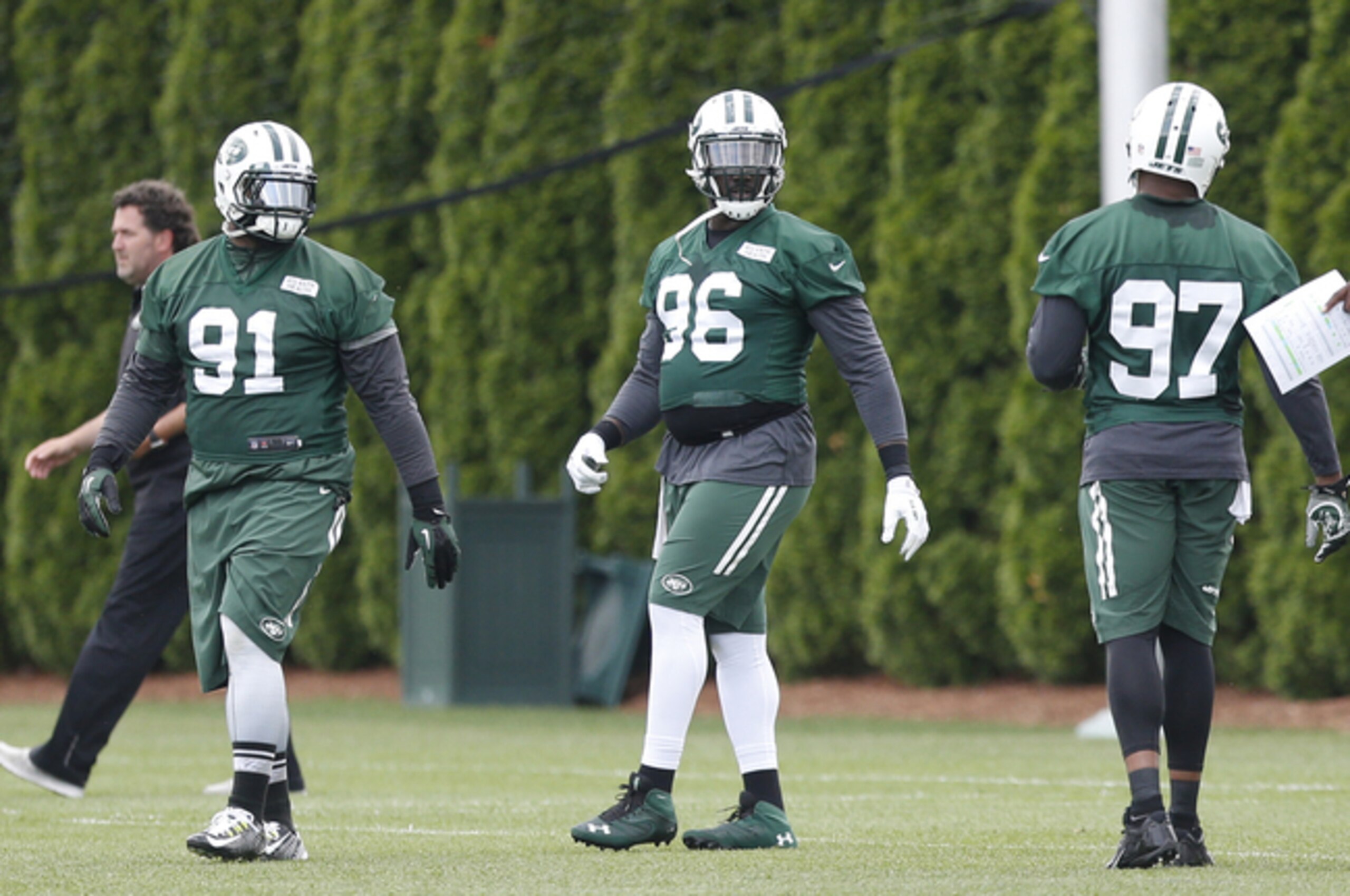 Sheldon Richardson (91), Muhammad Wilkerson (96) and Calvin pace (97) stretch before New York Jets practice Sheldon Richardson (91), Muhammad Wilkerson (96) and Calvin pace (97) stretch before New York Jets practice