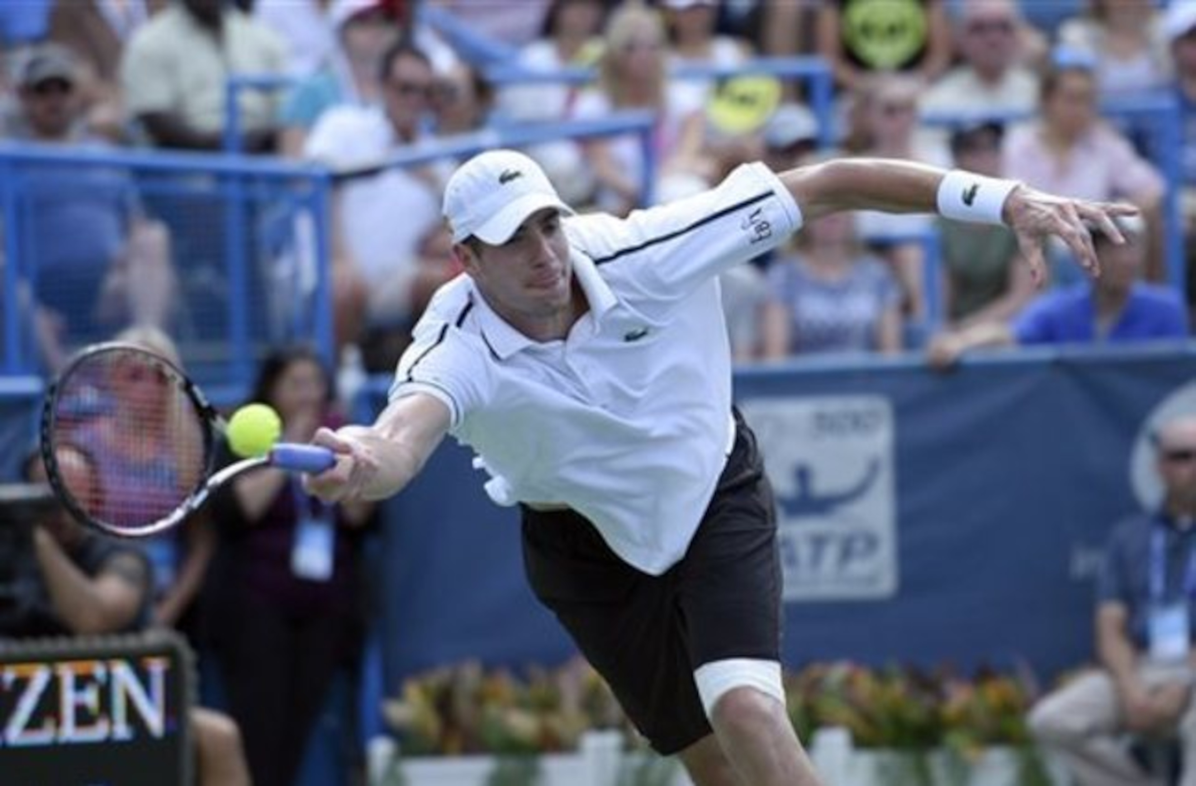 John Isner goes for forehand volley during the Western & Southern Open.