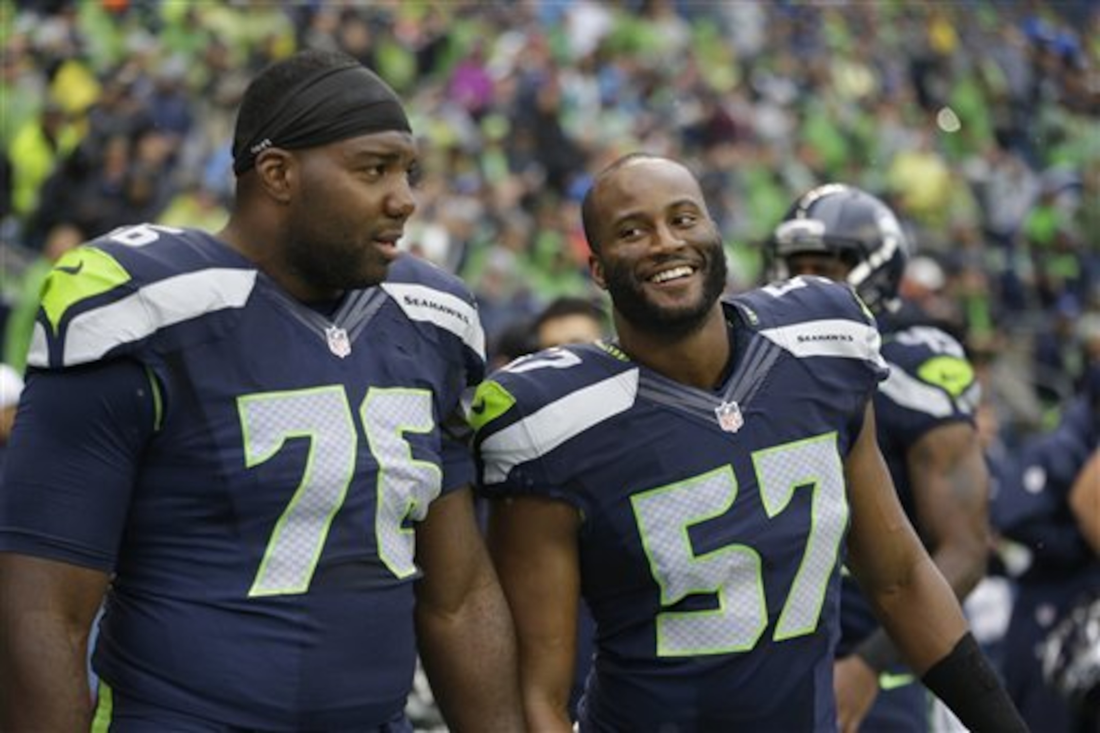 Russell Okung looks on from the sidelines, having sat the game out with a "sore shoulder."
