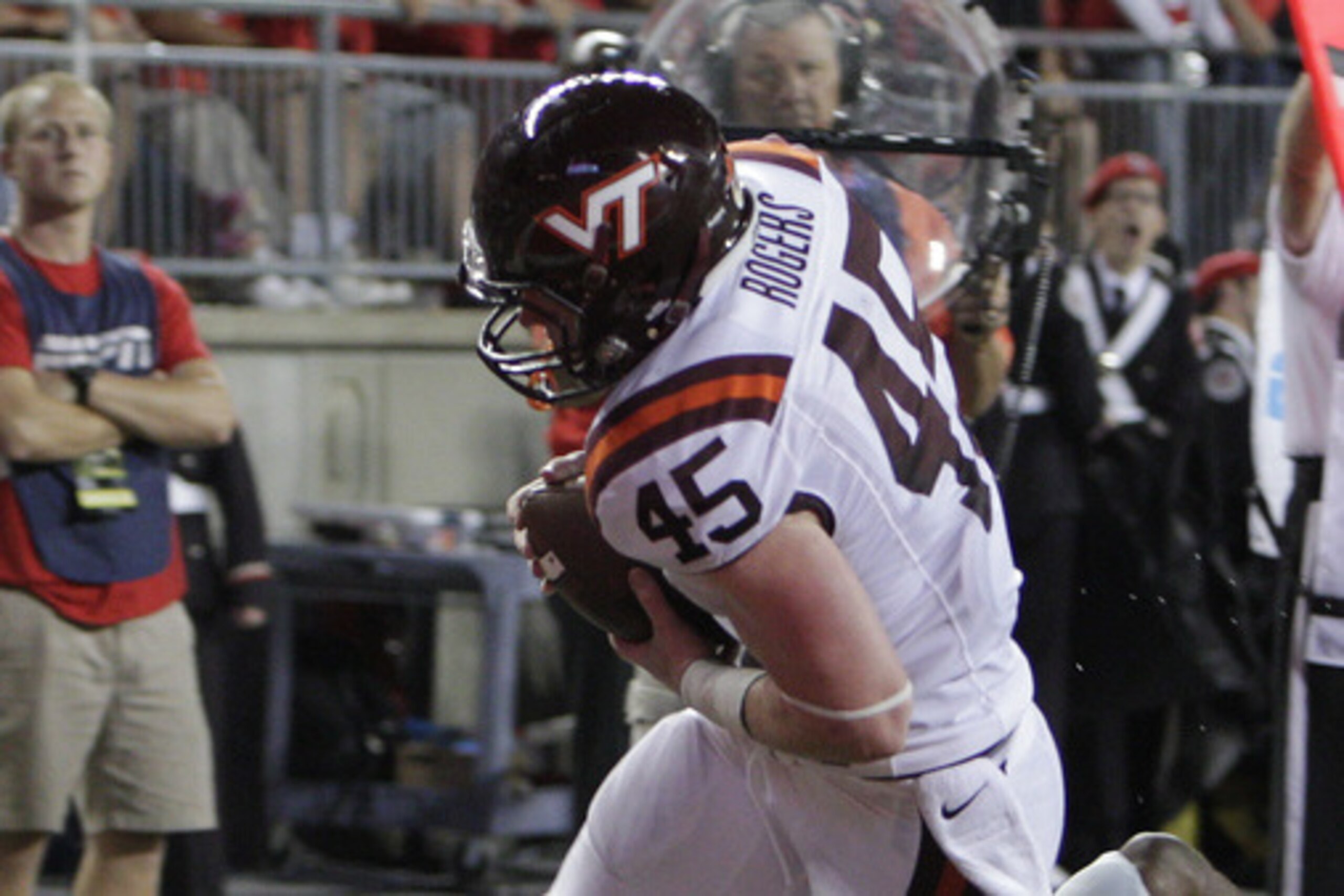 Fullback Sam Rogers rumbles over an Ohio State defender in last season's Hokies victory.