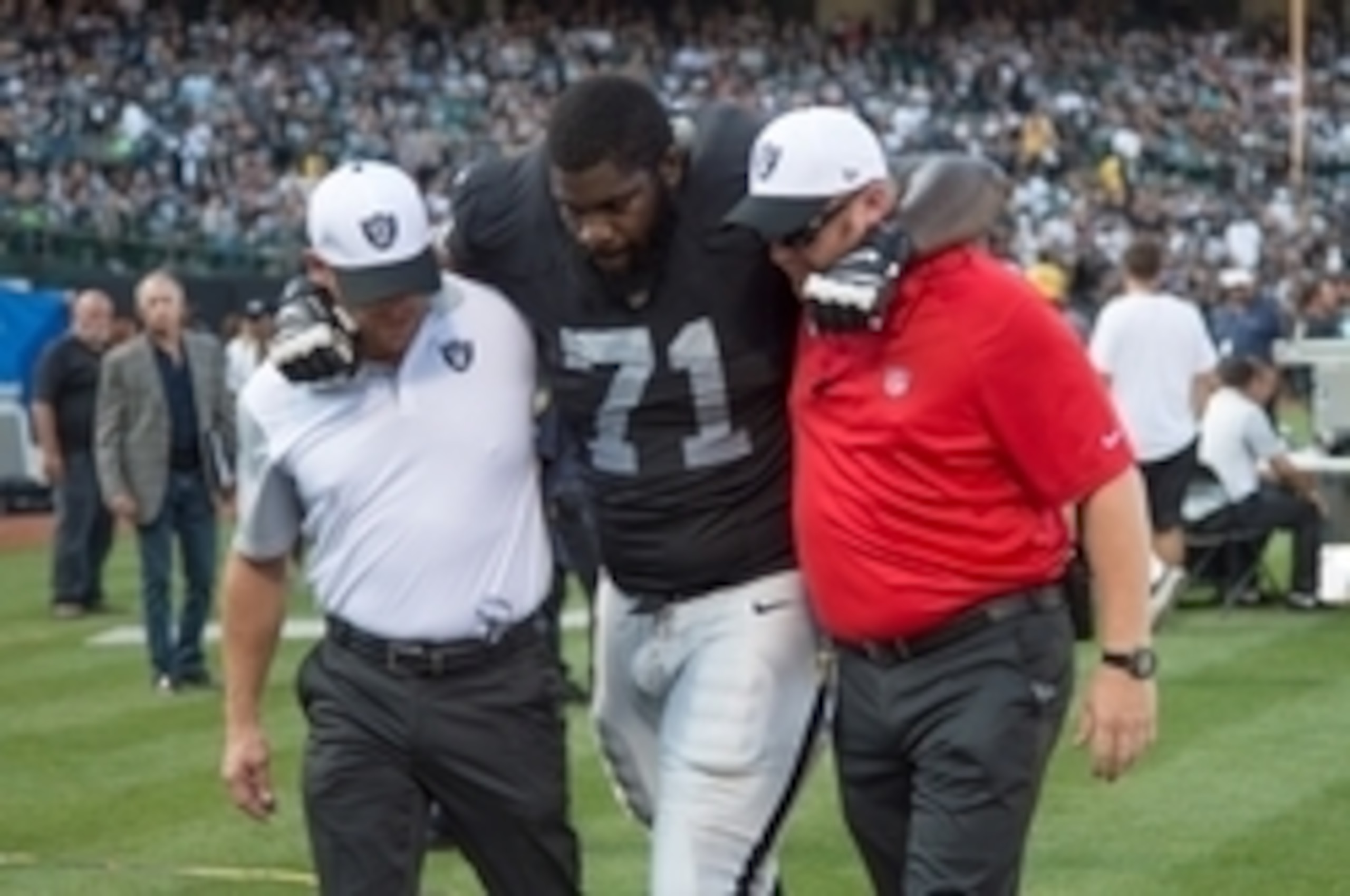 August 30, 2015; Oakland, CA, USA; Oakland Raiders tackle Menelik Watson (71) is helped off the field after an injury during the first quarter in a preseason NFL football game against the Arizona Cardinals at O.co Coliseum. The Cardinals defeated the Raid August 30, 2015; Oakland, CA, USA; Oakland Raiders tackle Menelik Watson (71) is helped off the field after an injury during the first quarter in a preseason NFL football game against the Arizona Cardinals at O.co Coliseum. The Cardinals defeated the Raid