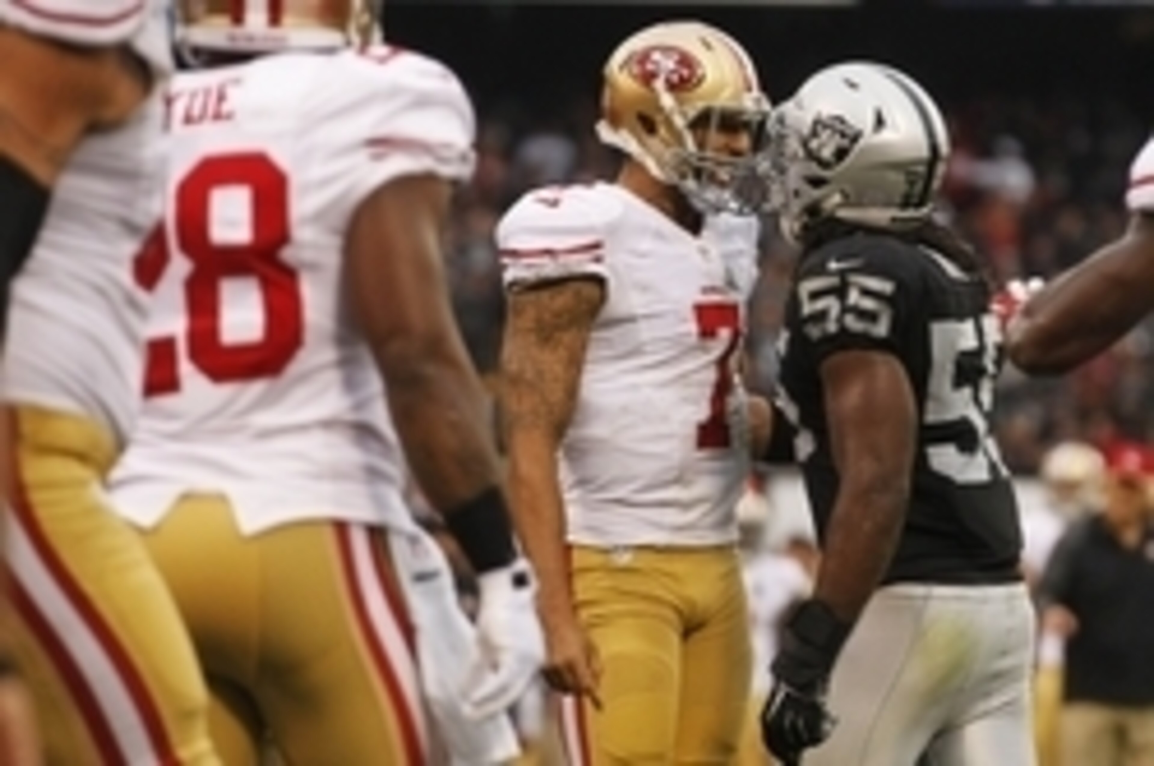 Dec 7, 2014; Oakland, CA, USA; San Francisco 49ers quarterback Colin Kaepernick (7) and Oakland Raiders outside linebacker Sio Moore (55) talk after a play in the third quarter at O.co Coliseum. Mandatory Credit: Cary Edmondson-USA TODAY Sports