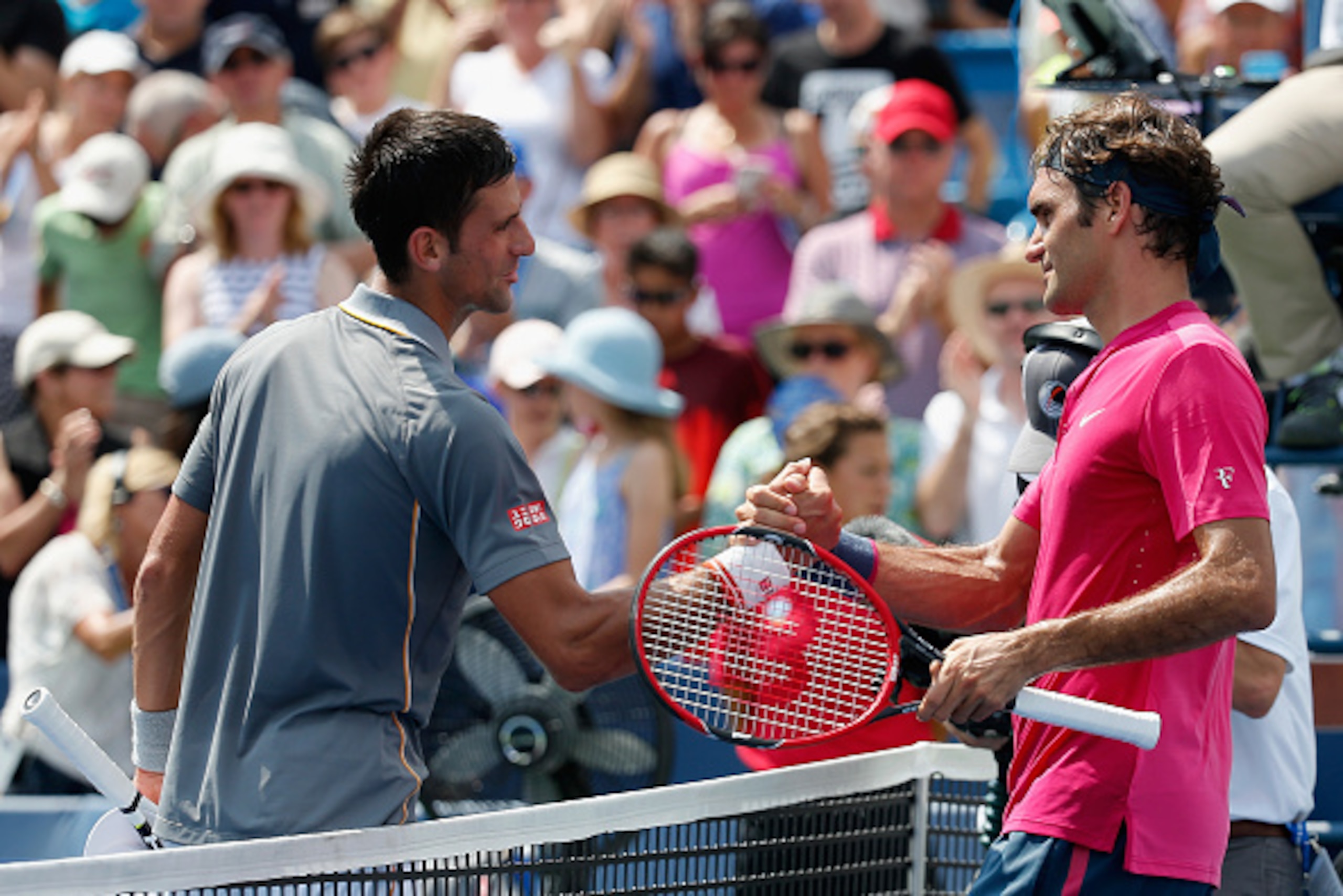 Novak Djokovic congratulates Roger Federer at the 2015 Western & Southern Open.