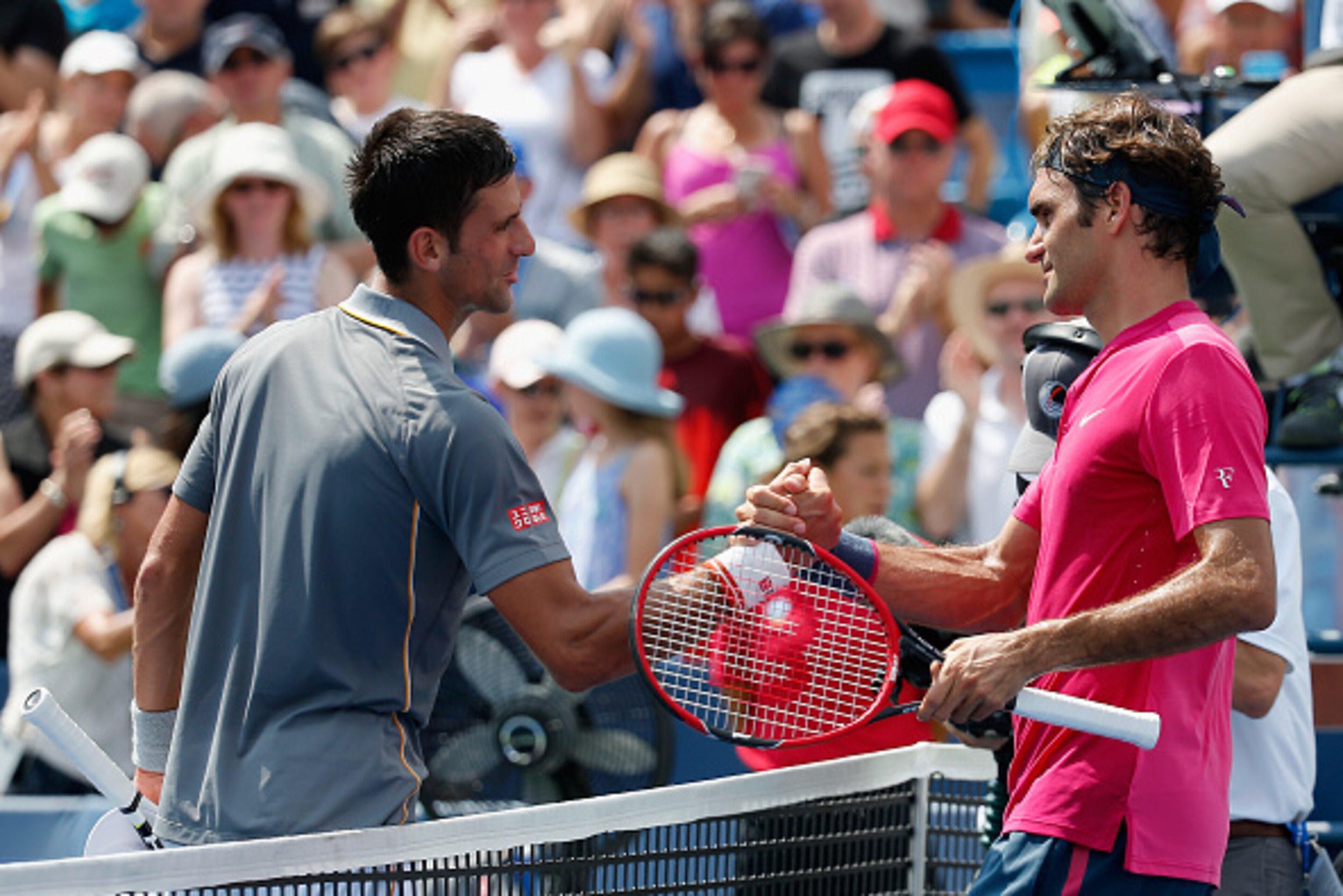 Novak Djokovic congratulates Roger Federer at the 2015 Western & Southern Open.
