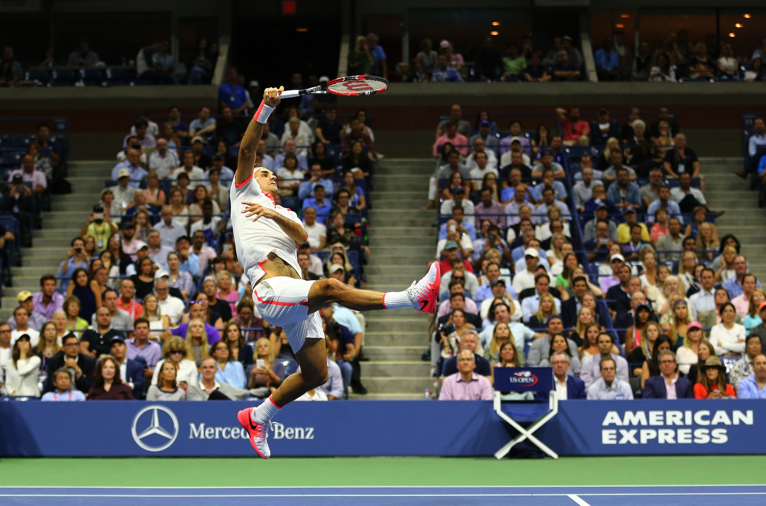 Federer hits an overhead shot against Stan Wawrinka in the semifinals at the U.S. Open.