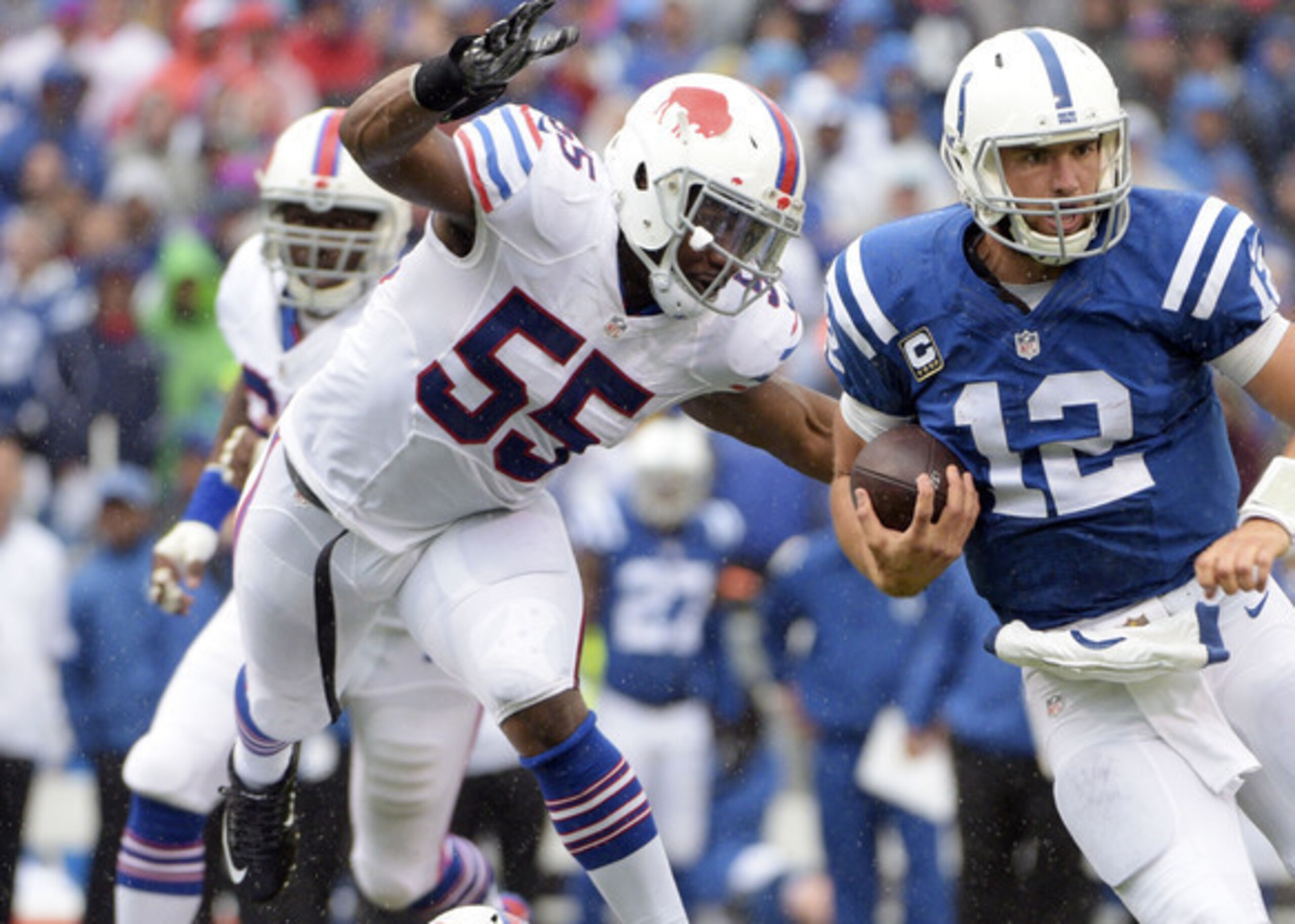 Buffalo's Jerry Hughes and Indianapolis QB Luck.
