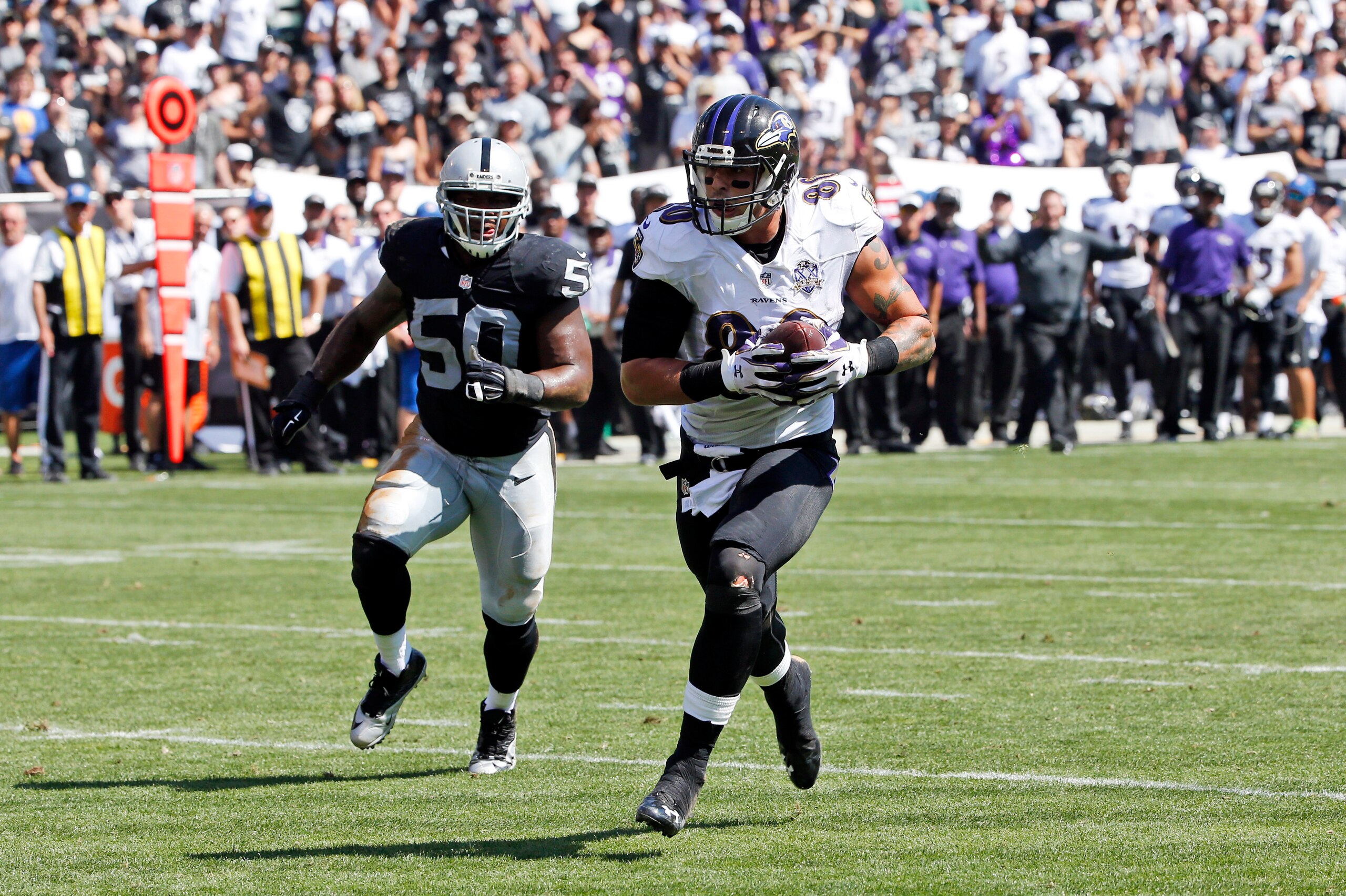 Raiders inside linebacker Curtis Lofton chasing Ravens tight end Crockett Gillmore.