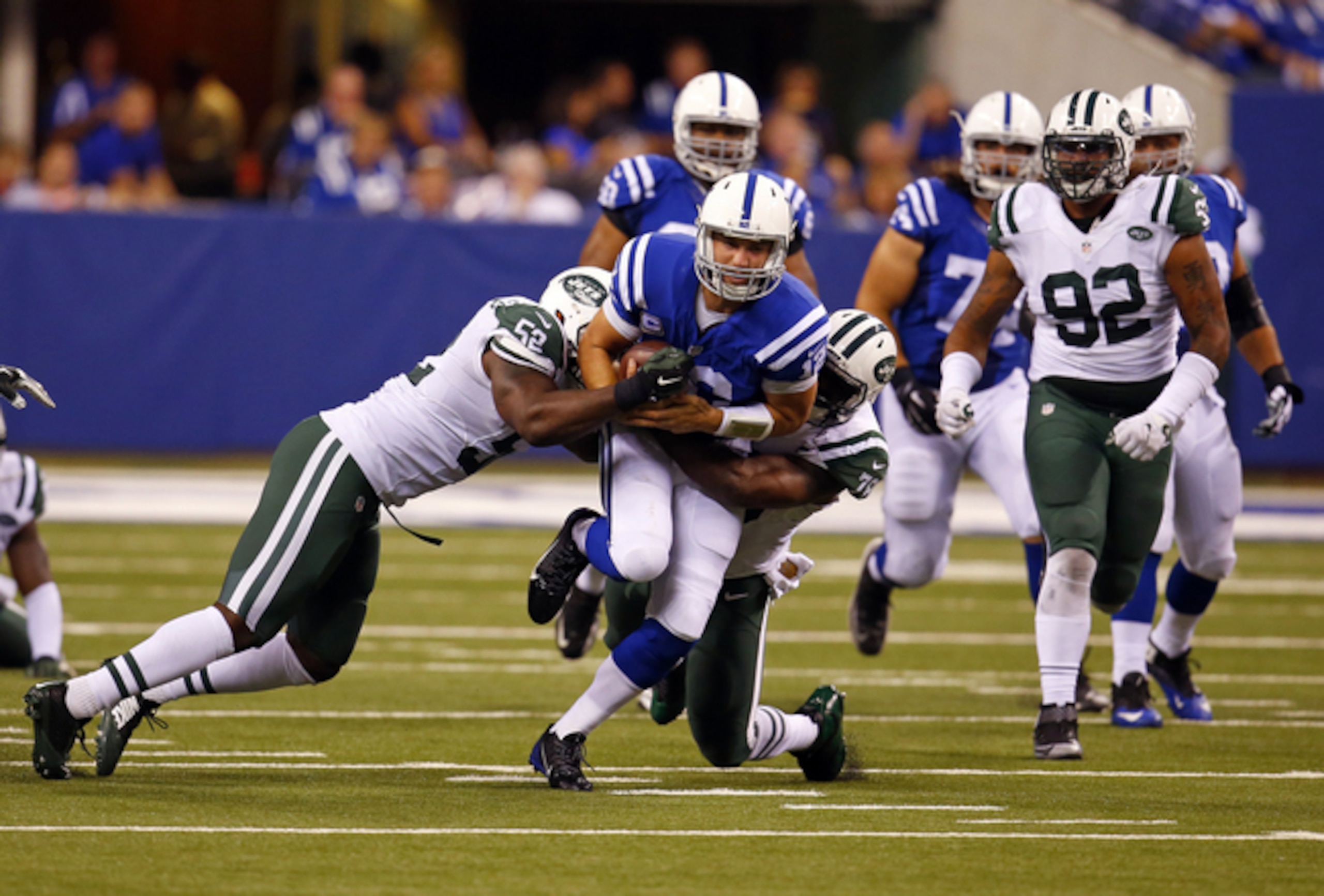 Andrew Luck is tackled and fumbles the football against the Jets