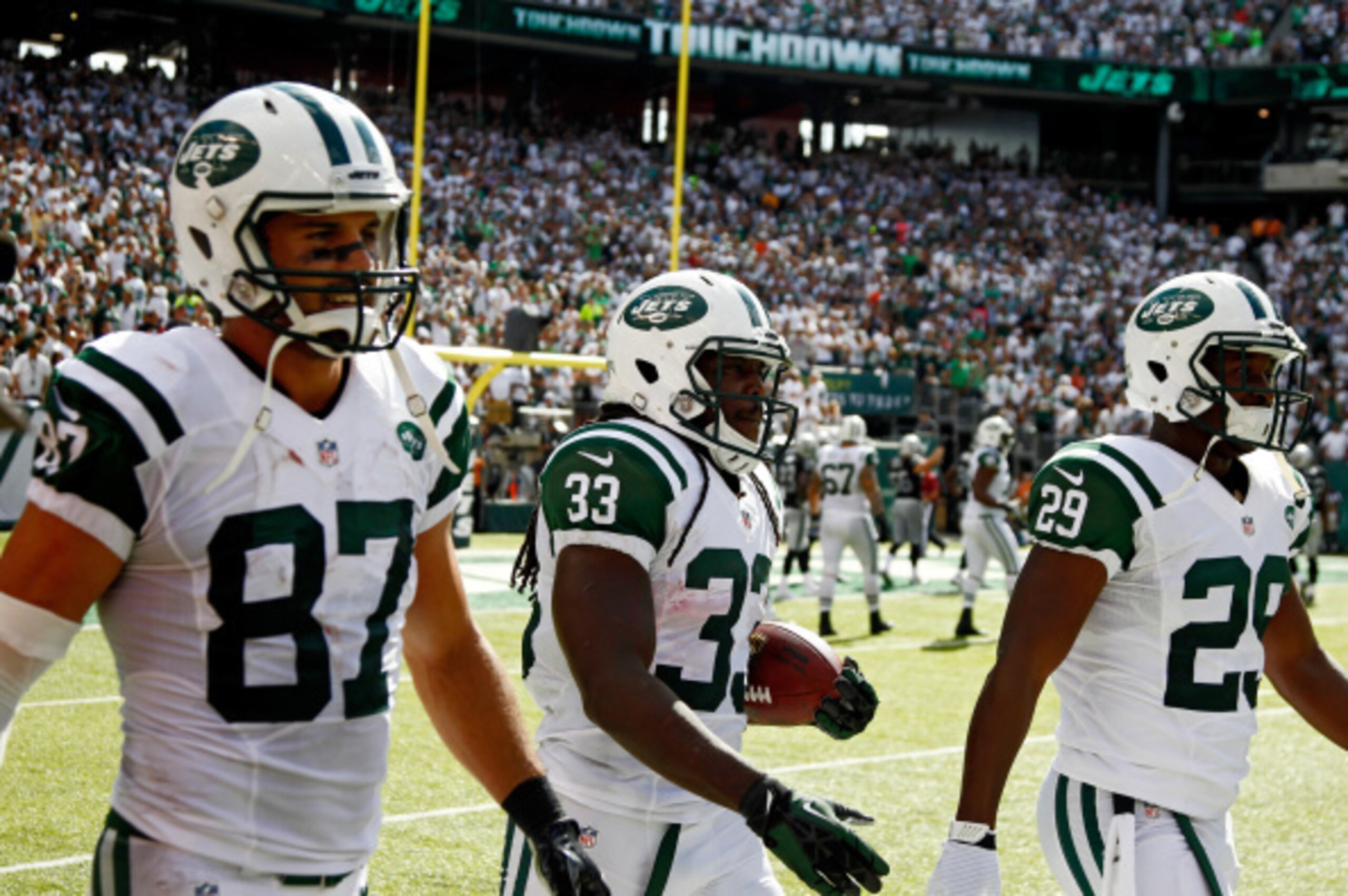 EAST RUTHERFORD, NJ - SEPTEMBER 07:   Chris Ivory #33 of the New York Jets walks back with teammates  Eric Decker #87 and  Bilal Powell #29 after a fourth quarter touchdown run against the Oakland Raiders at MetLife Stadium on September 7, 2014 in East Ru