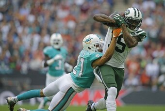 Brandon Marshall hauls in a 58-yard reception against the Miami Dolphins