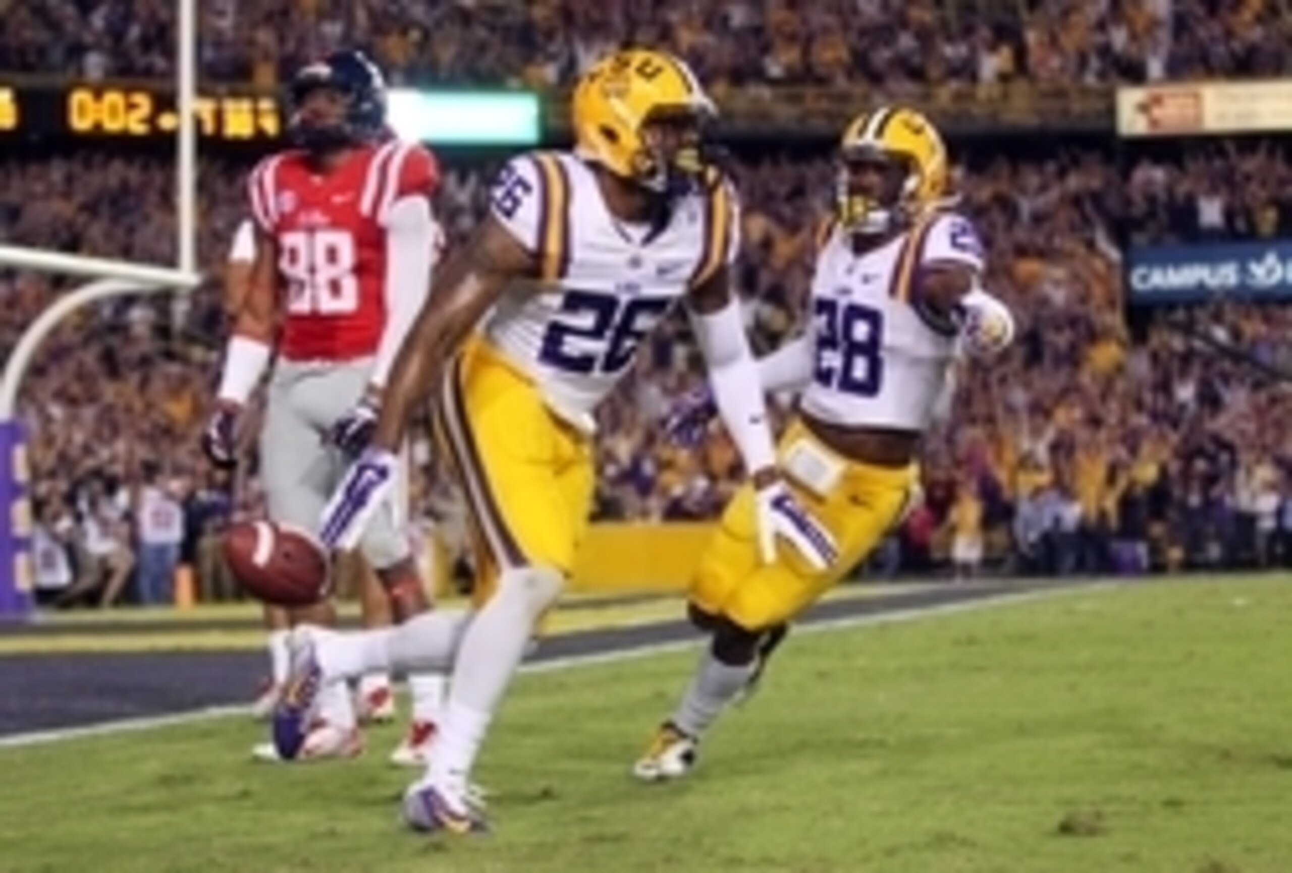 Oct 25, 2014; Baton Rouge, LA, USA; LSU Tigers safety Ronald Martin (26) is congratulated by safety Jalen Mills (28) after Martin intercept the ball in front of Mississippi Rebels wide receiver Cody Core (88) with seconds left in the fourth quarter at Tig