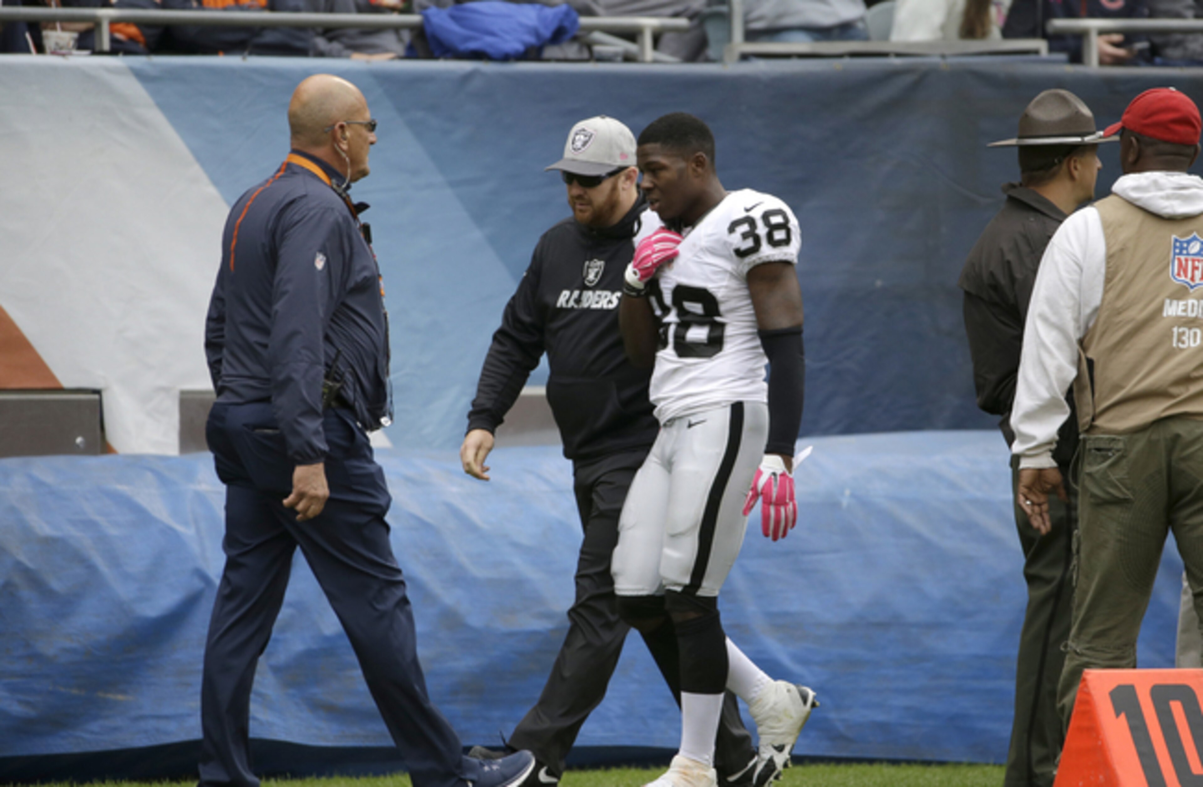 Cornerback T.J. Carrie walks off the field with a chest injury.