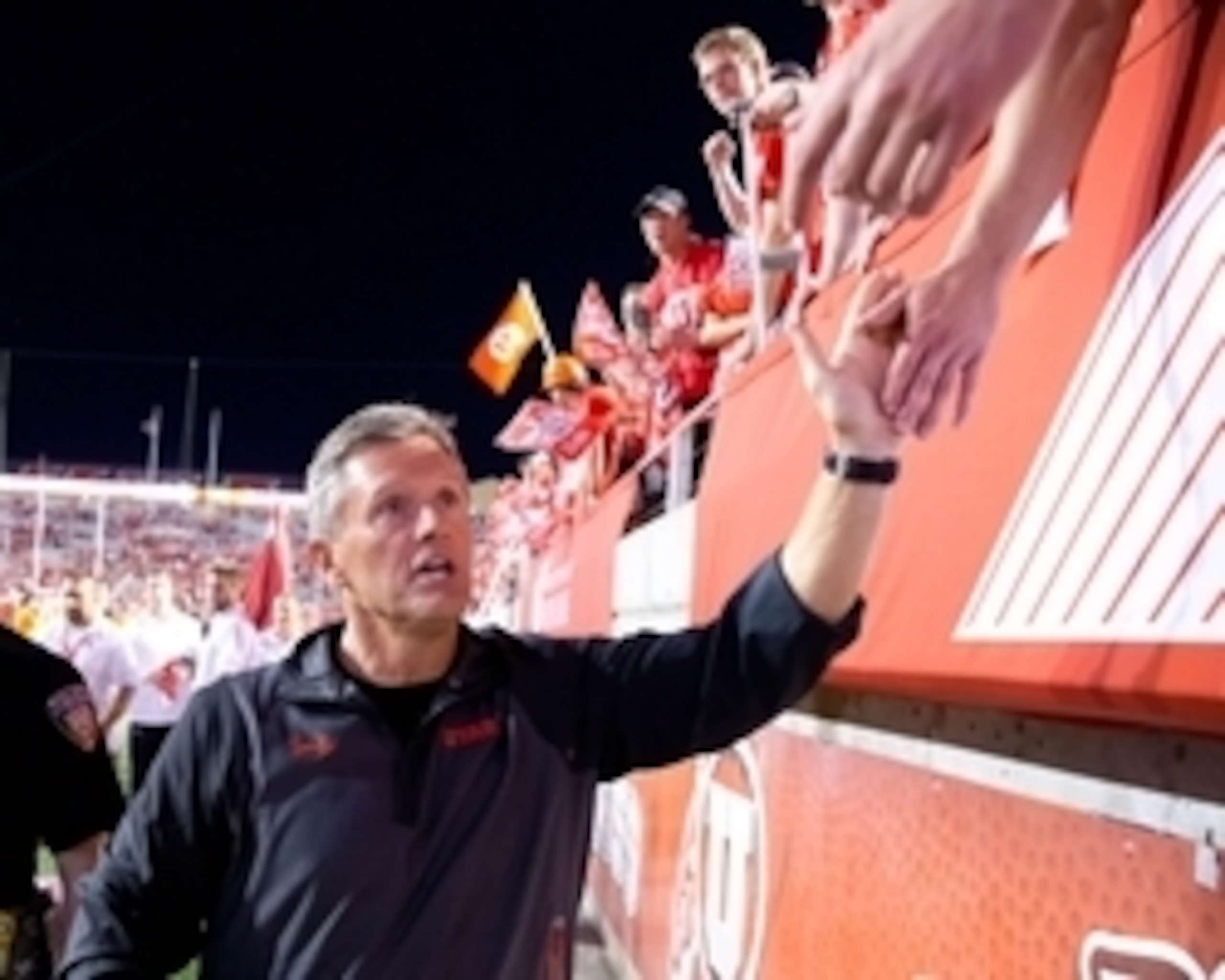 Oct 10, 2015; Salt Lake City, UT, USA; Utah Utes head coach Kyle Whittingham high-fives fans following Utah's 30-24 defeat of the California Golden Bears at Rice-Eccles Stadium. Utah won 30-24. Mandatory Credit: Russ Isabella-USA TODAY Sports
