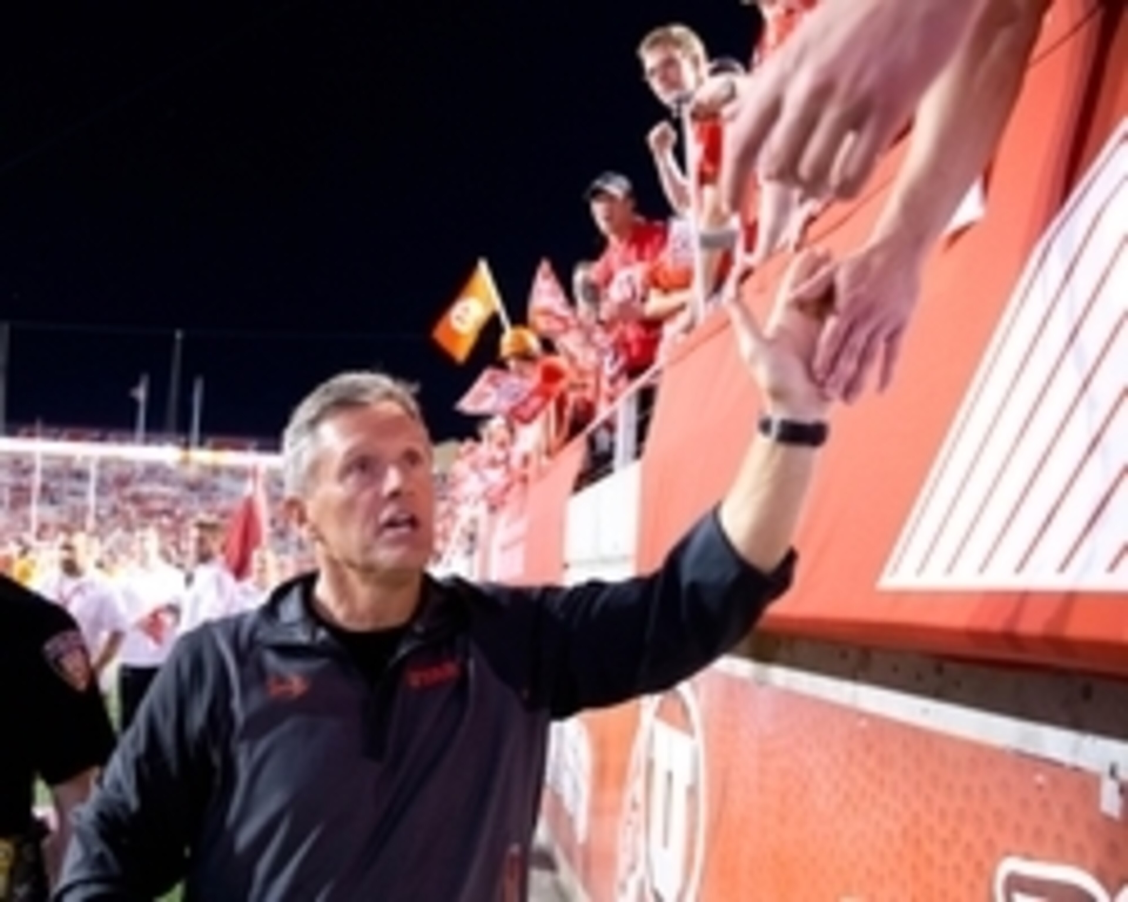 Oct 10, 2015; Salt Lake City, UT, USA; Utah Utes head coach Kyle Whittingham high-fives fans following Utah's 30-24 defeat of the California Golden Bears at Rice-Eccles Stadium. Utah won 30-24. Mandatory Credit: Russ Isabella-USA TODAY Sports