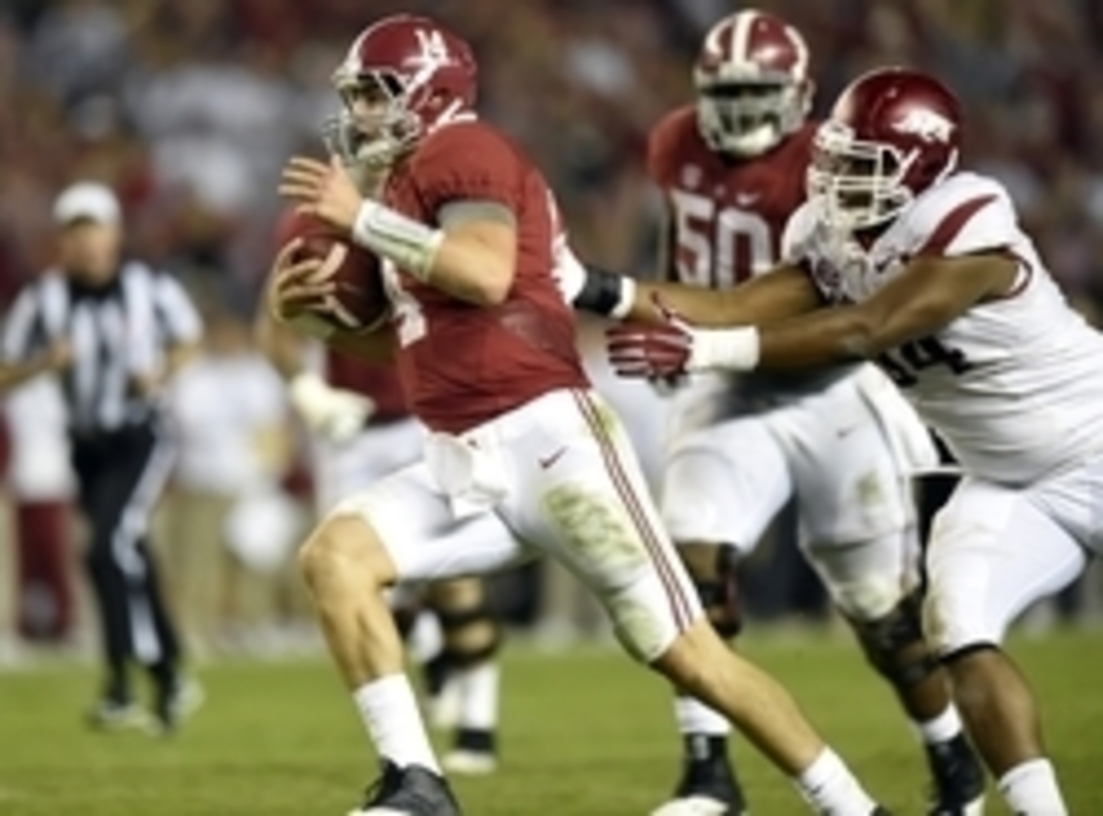 Oct 10, 2015; Tuscaloosa, AL, USA; Alabama Crimson Tide quarterback Jake Coker (14) scrambles up the field against Arkansas Razorbacks defensive lineman Taiwan Johnson (94) during the fourth quarter at Bryant-Denny Stadium. Mandatory Credit: John David Me