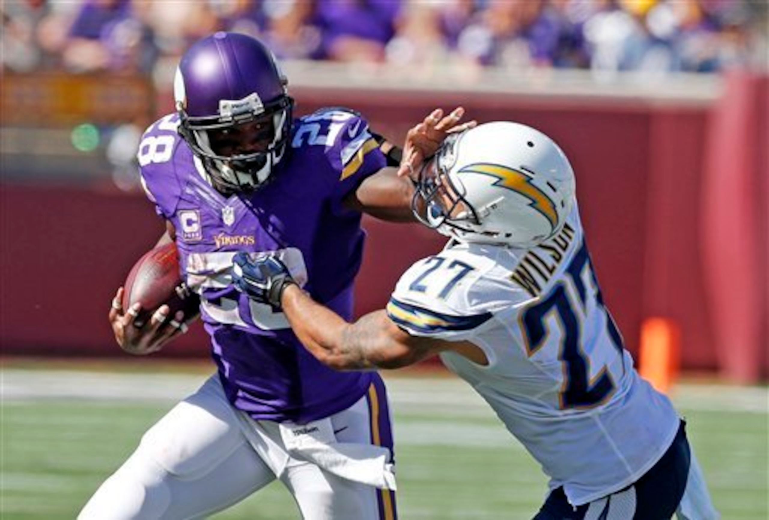 Vikings running back Adrian Peterson stiff-arms a Chargers defender. Vikings running back Adrian Peterson stiff-arms a Chargers defender.