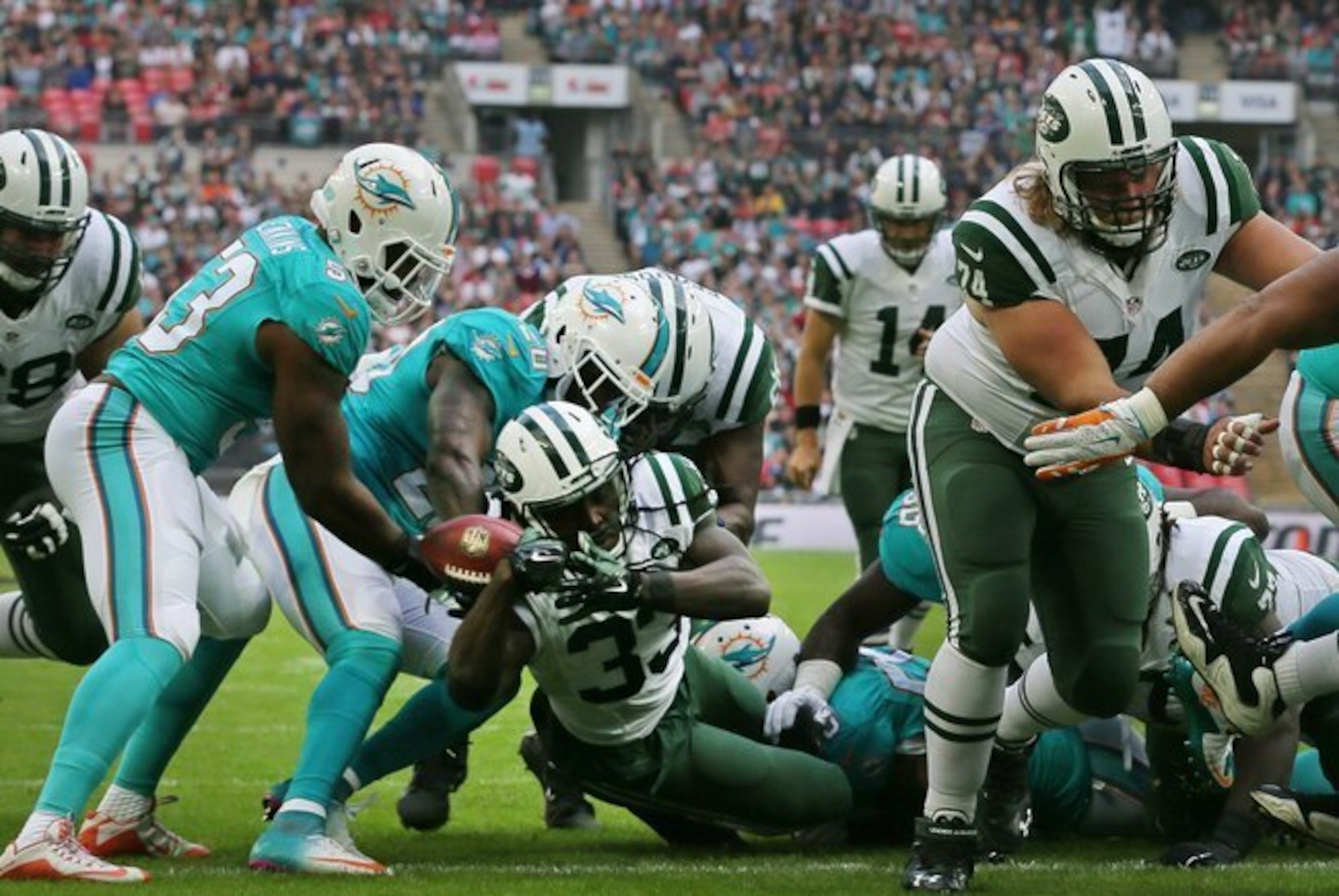 Chris Ivory scores a touchdown against the Dolphins in London.