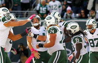 Ryan Fitzpatrick gets hugs from teammates after scoring a touchdown.