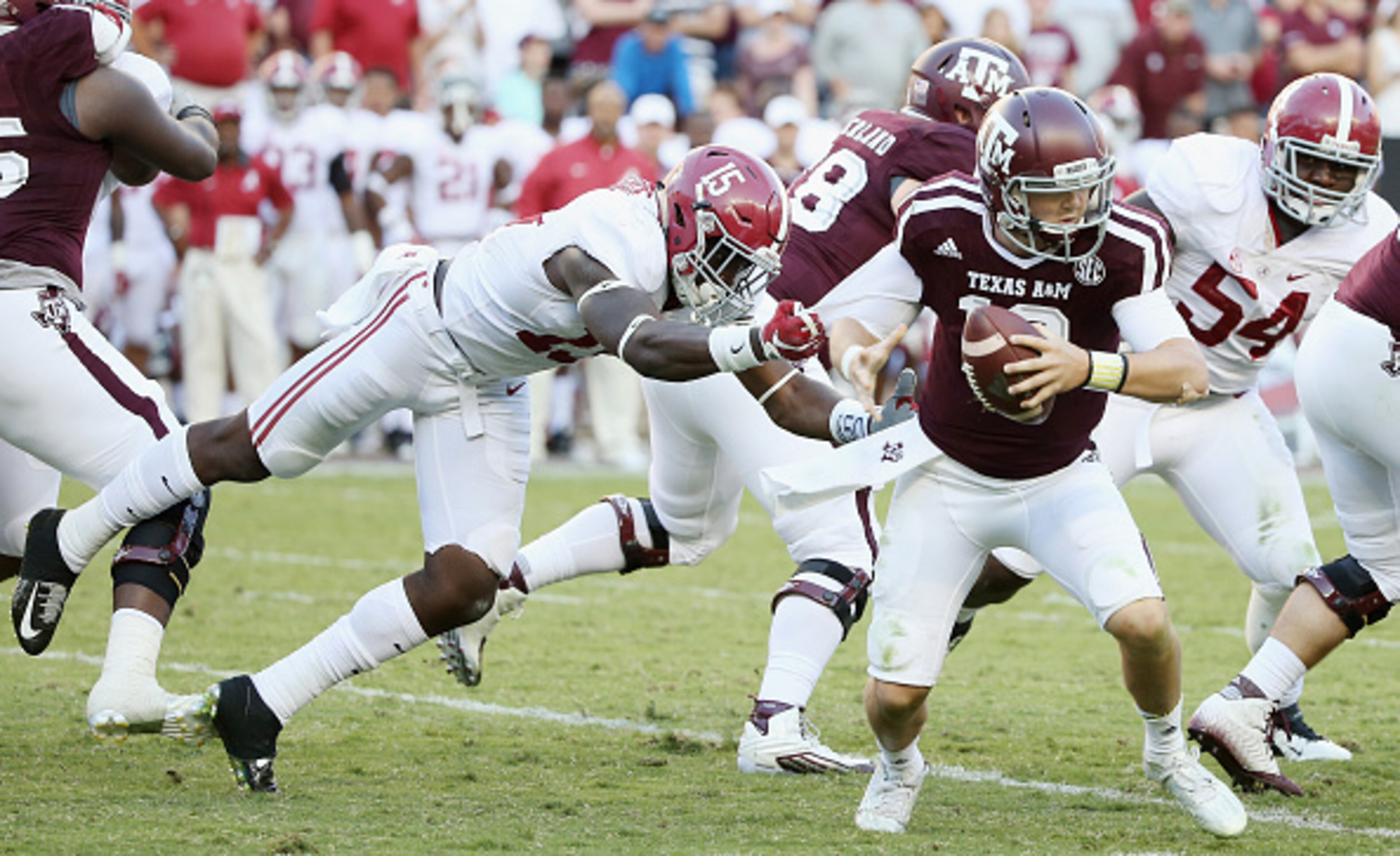 COLLEGE STATION, TX - OCTOBER 17:  Ronnie Harrison #15 of the Alabama Crimson Tide tackles Kyle Allen #10 of the Texas A&M Aggies in the second half of their game at Kyle Field on October 17, 2015 in College Station, Texas.  (Photo by Scott Halleran/Getty