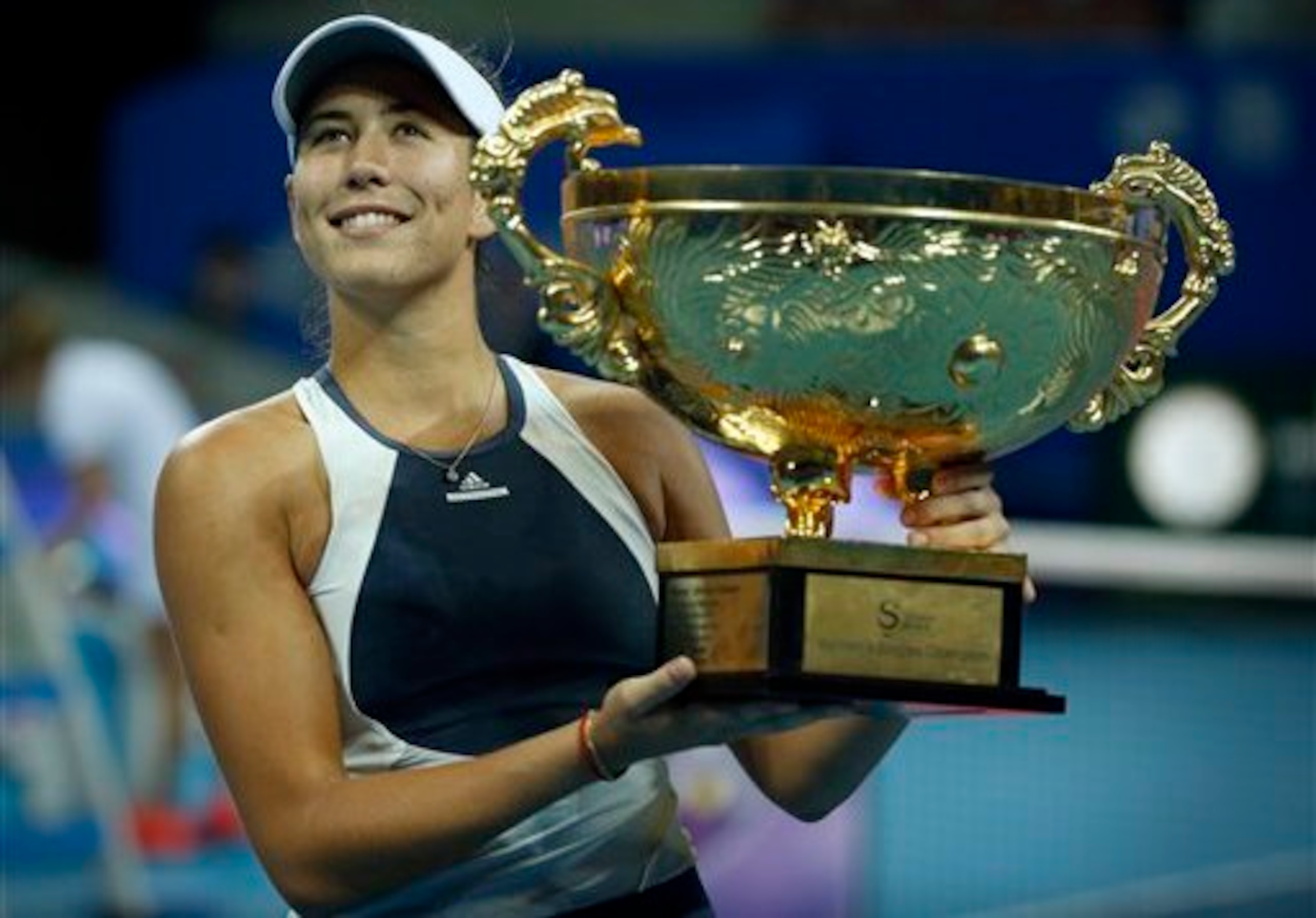 Garbine Muguruza hoists the trophy after winning the title in Beijing. Garbine Muguruza hoists the trophy after winning the title in Beijing.