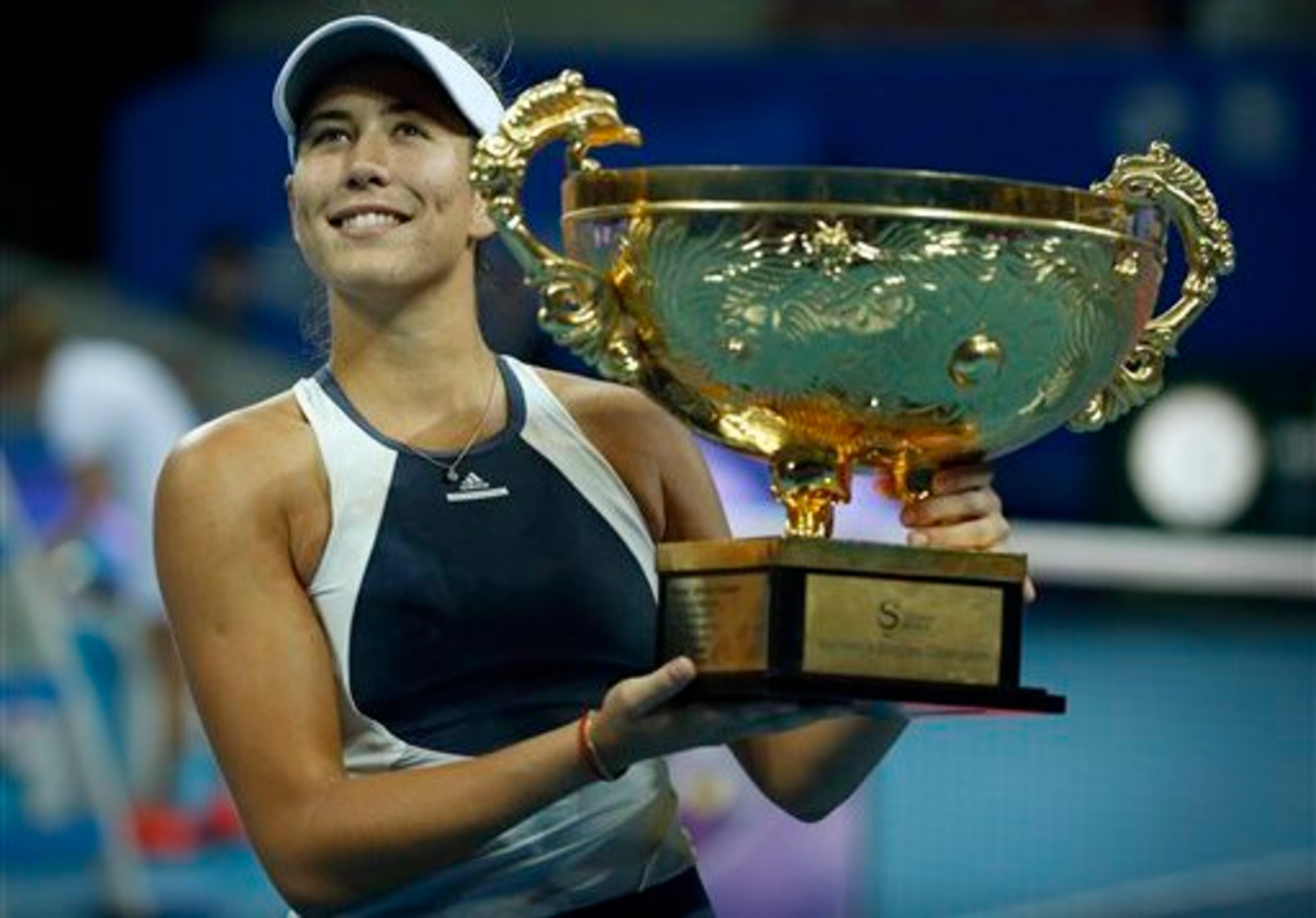 Garbine Muguruza hoists the trophy after winning the title in Beijing. Garbine Muguruza hoists the trophy after winning the title in Beijing.